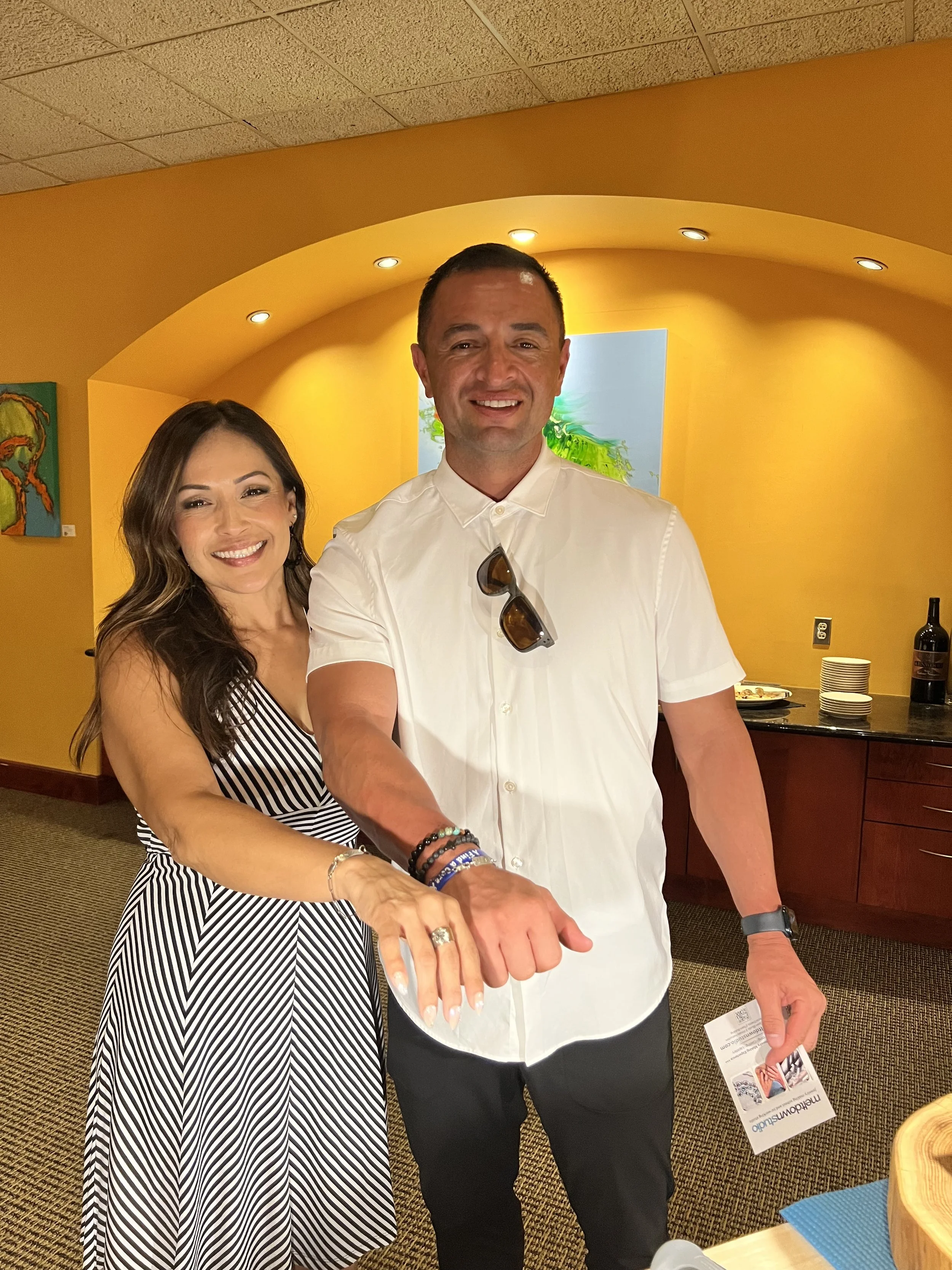 Jewelry workshop in Albuquerque with two participants posing.