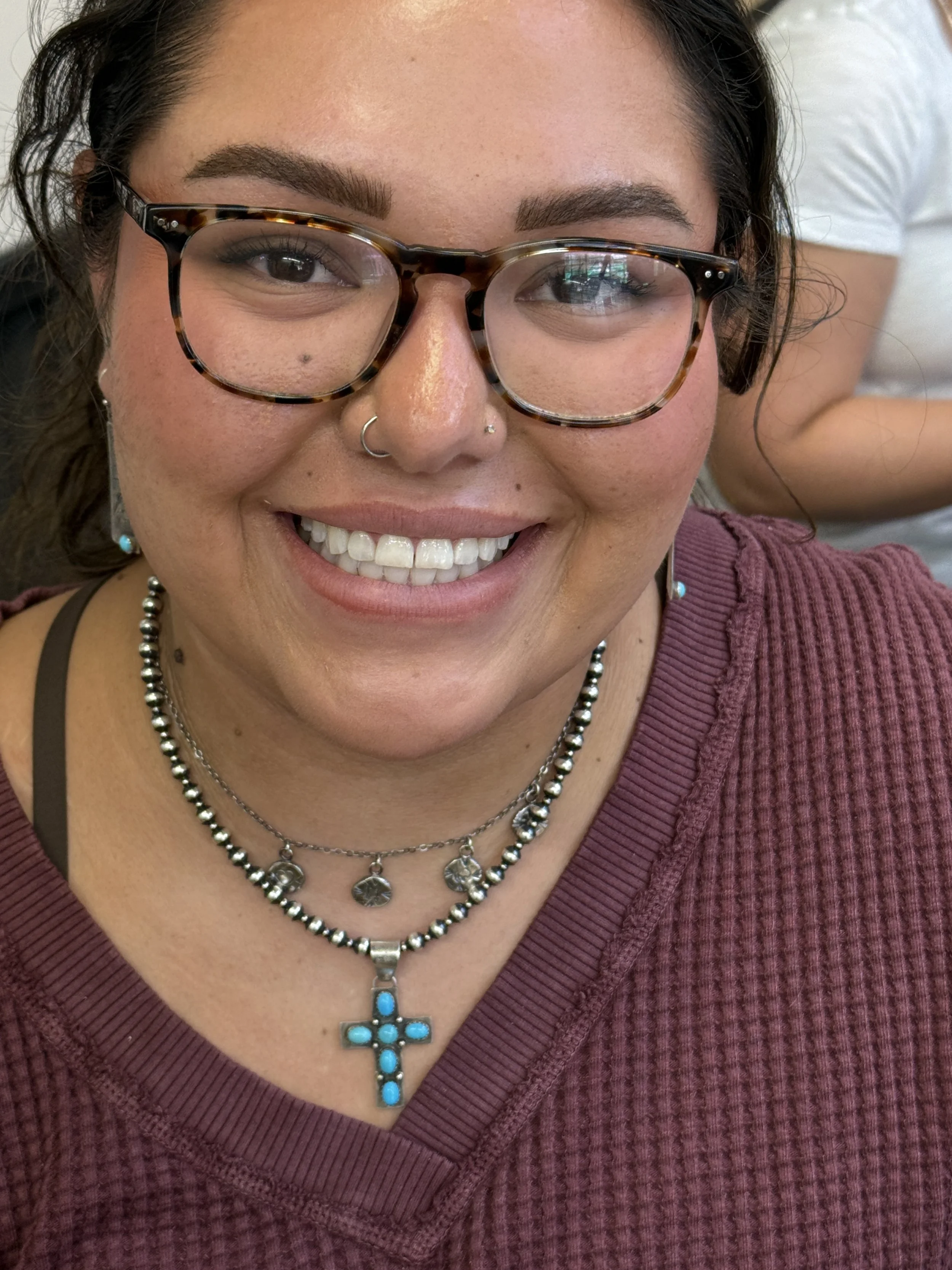 Jewelry making classes Albuquerque with a student wearing her handmade necklace.