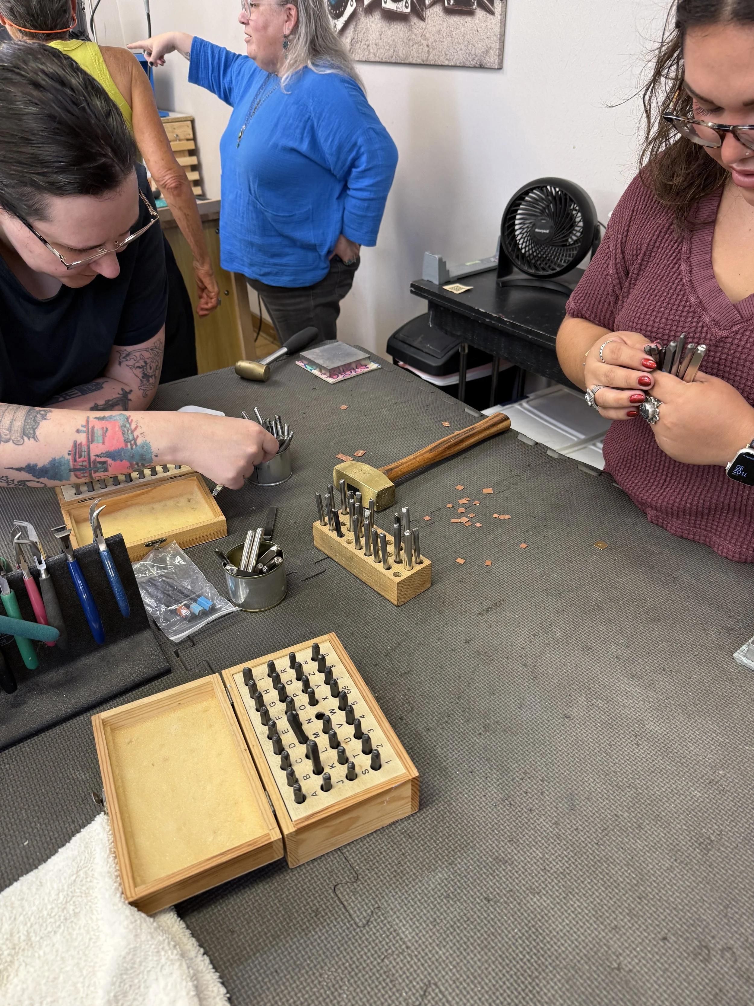 Jewelry making classes Albuquerque with students working on their pieces.