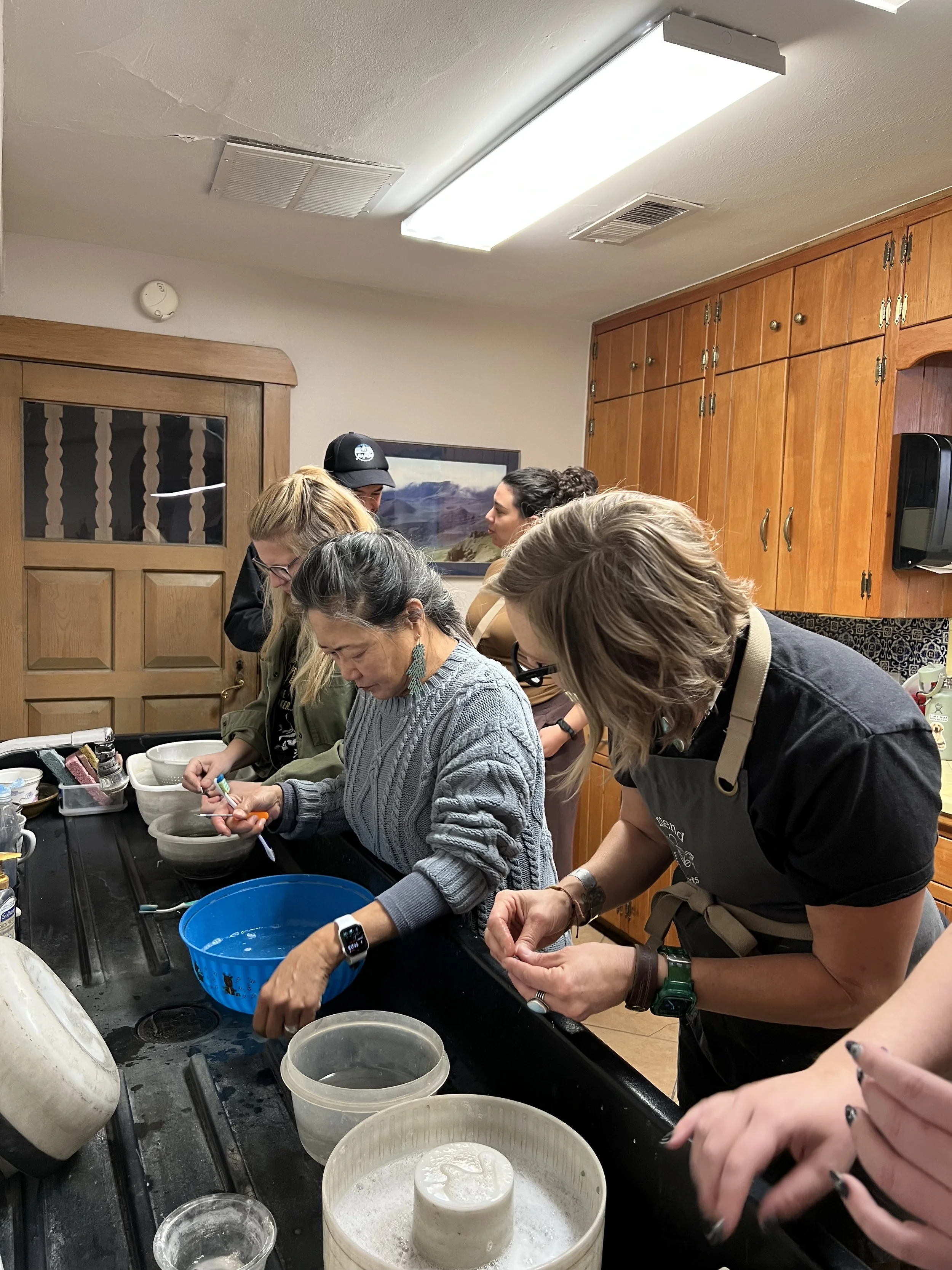 Students working on jewelry projects together at Meltdown Studio