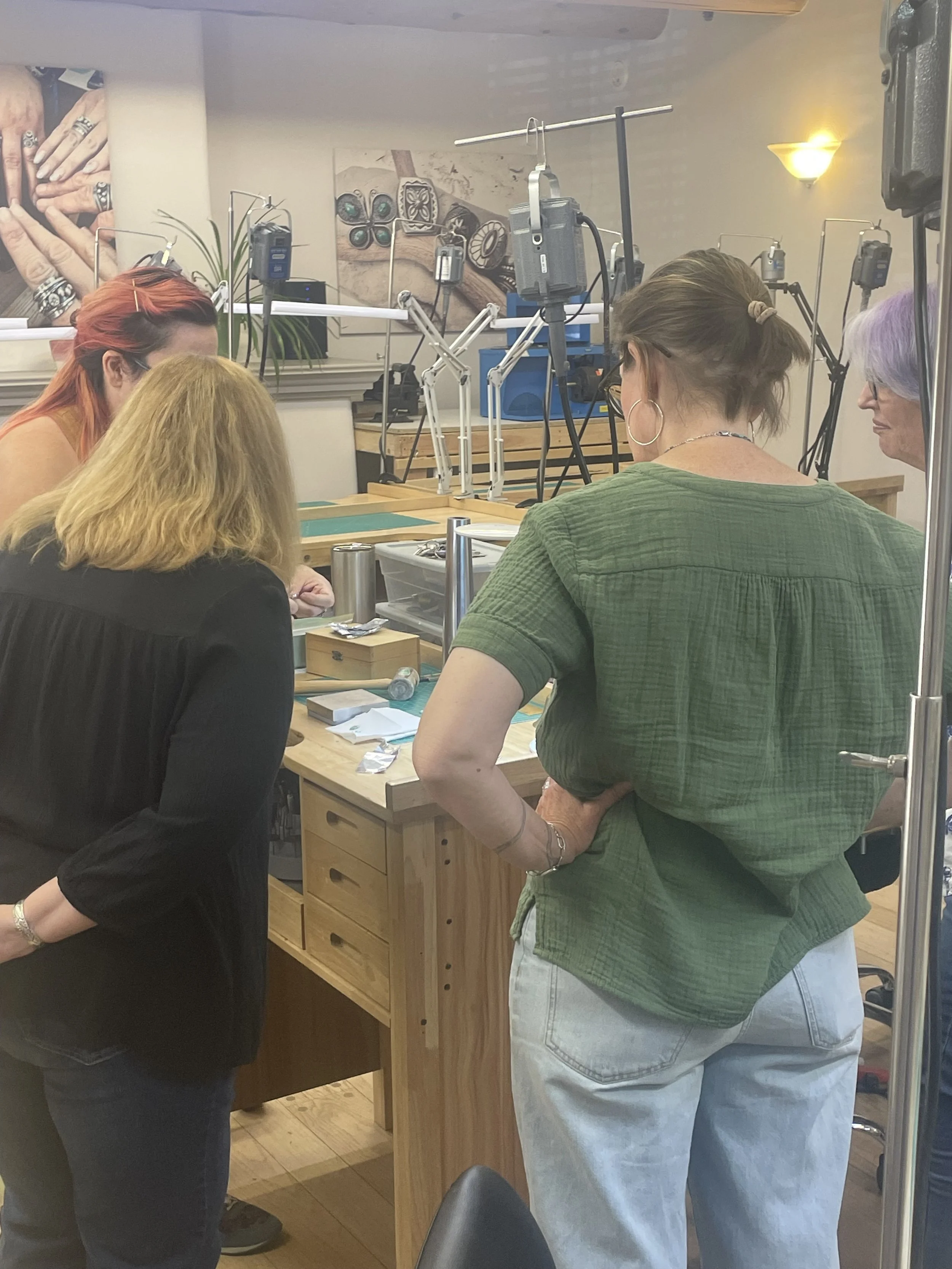 Students working together during a jewelry-making workshop at Meltdown Studio