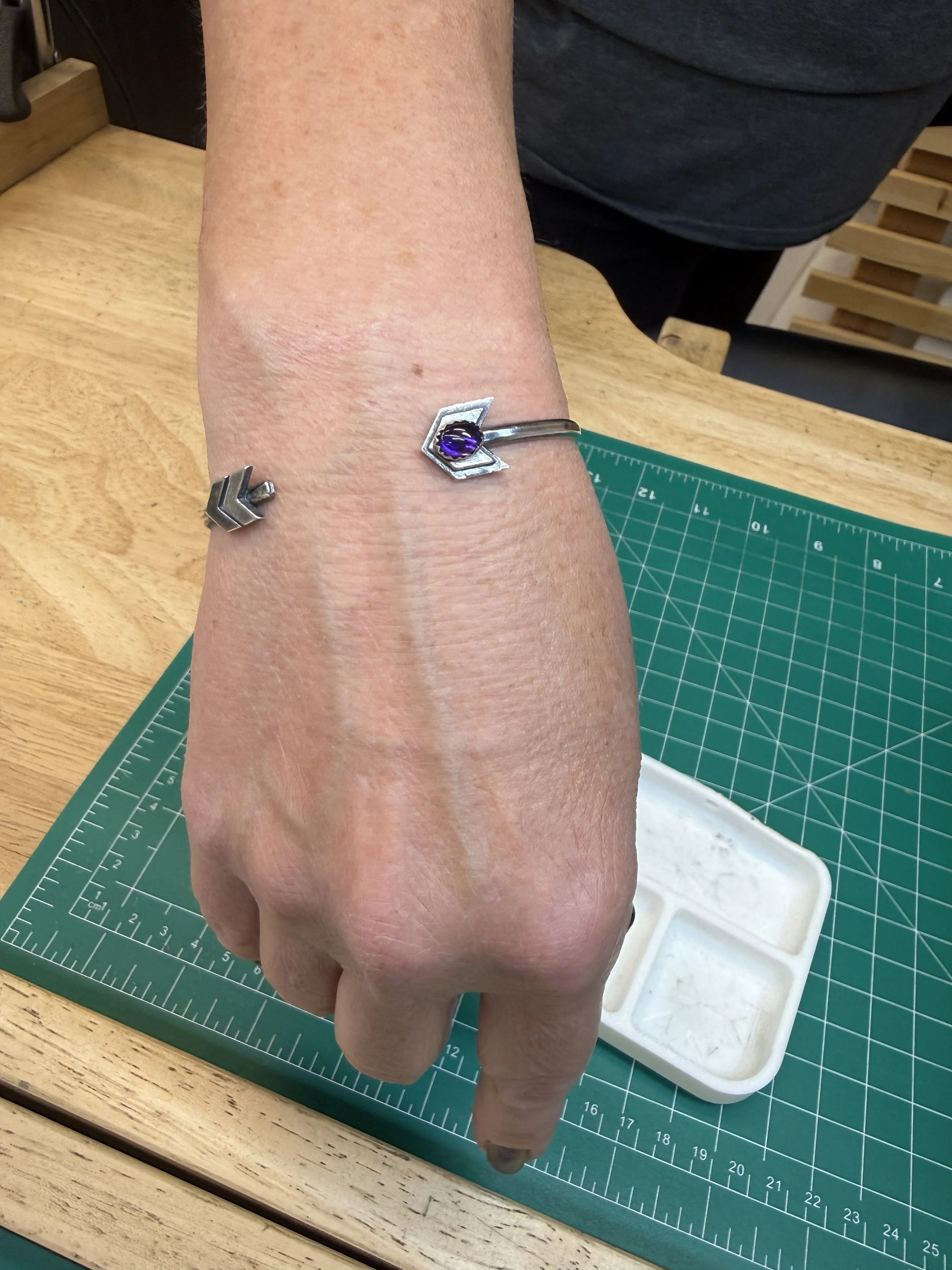 Student wearing a finished turquoise Arrow Cuff Bracelet