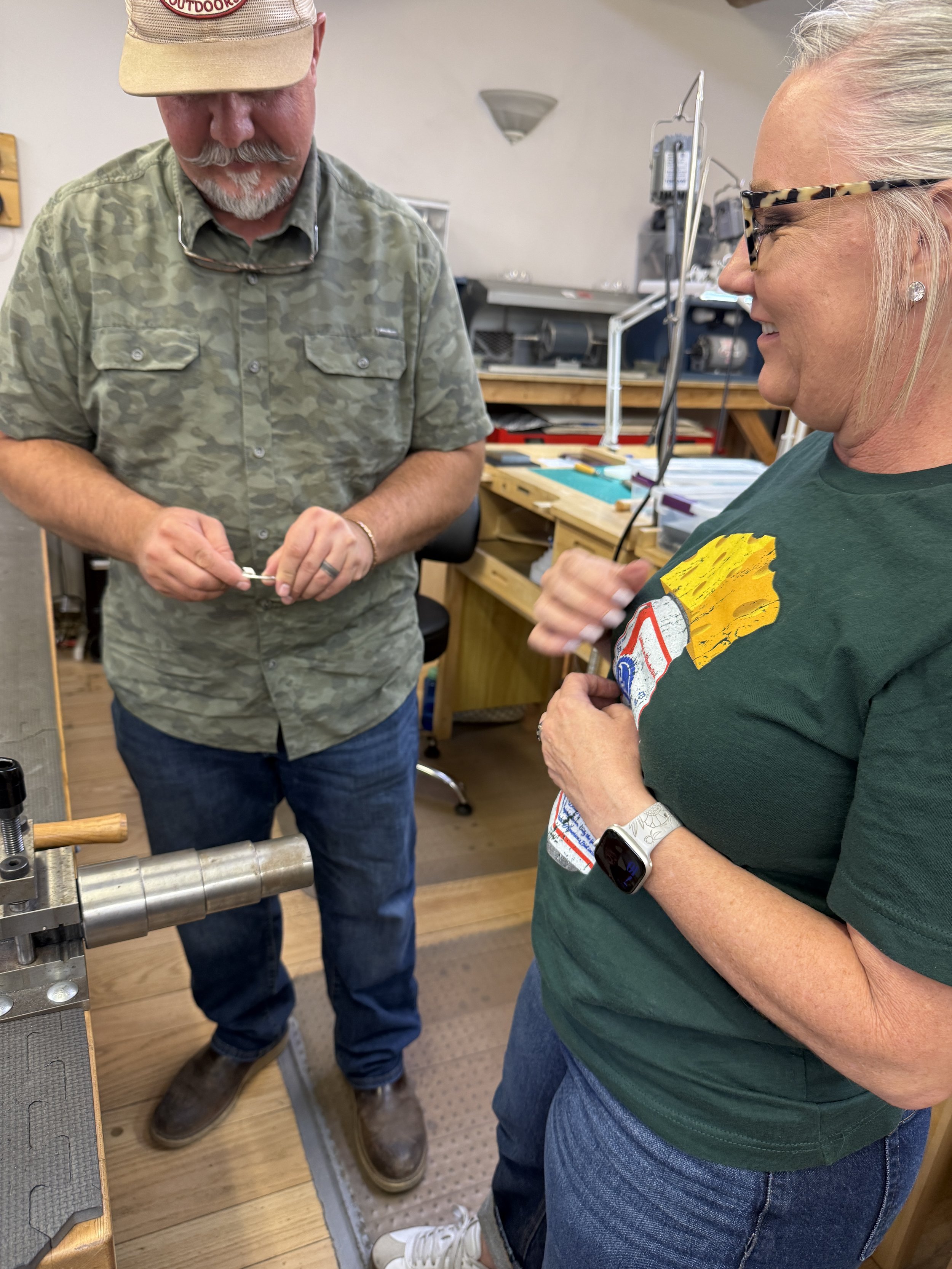 Instructor helping a student shape a jewelry piece