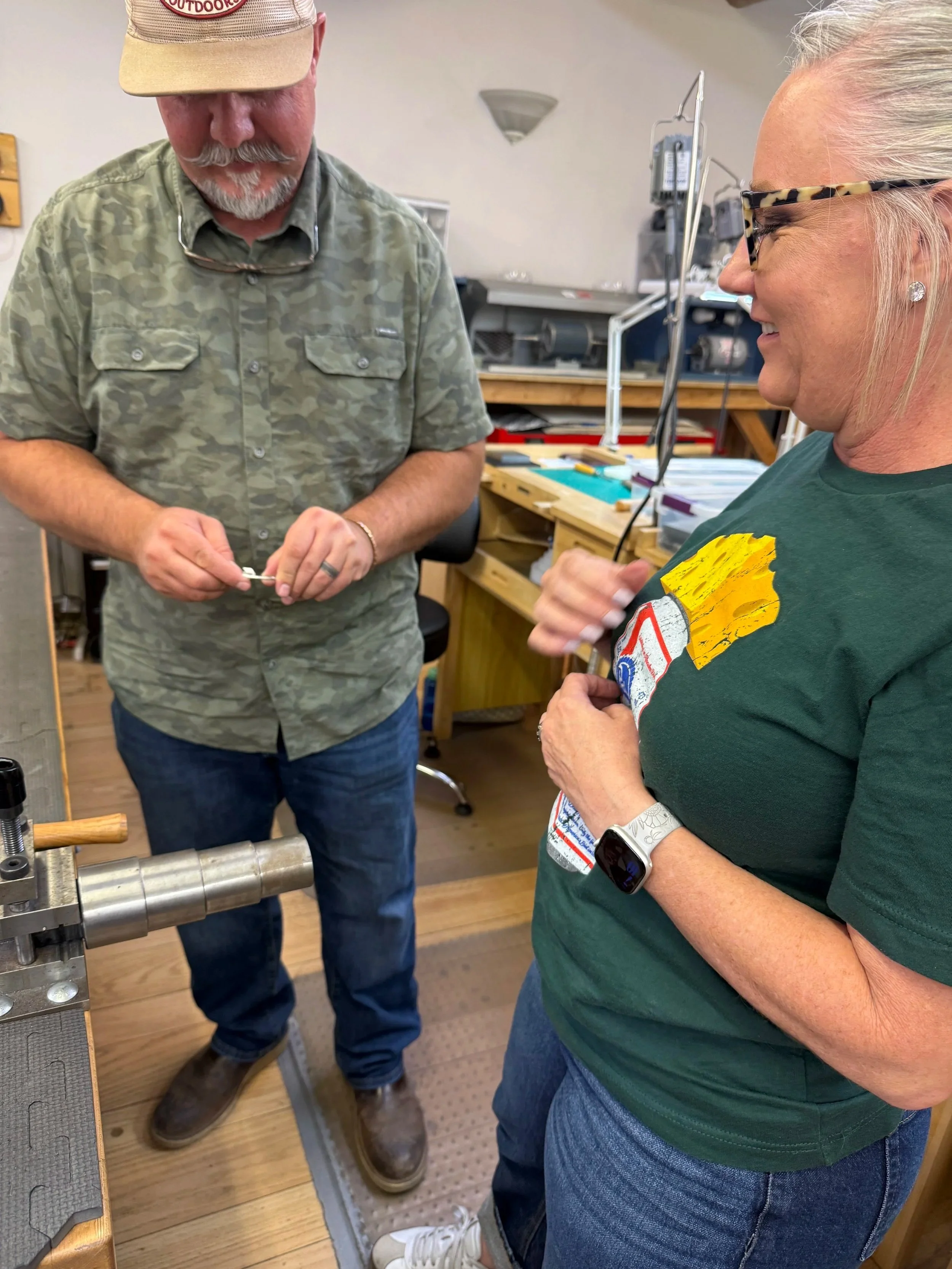 Instructor helping a student shape a jewelry piece