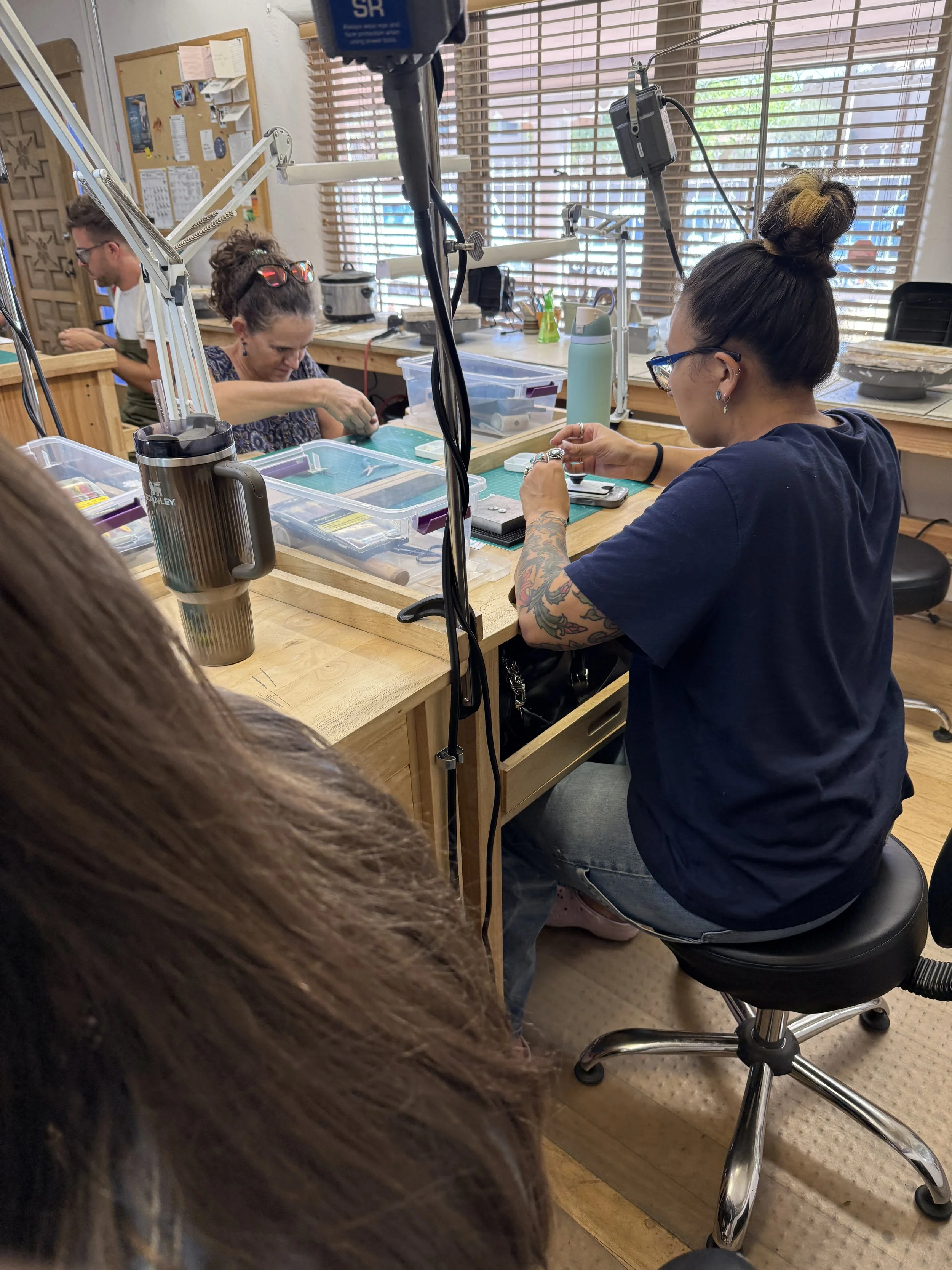 Students working on their rings at the bench