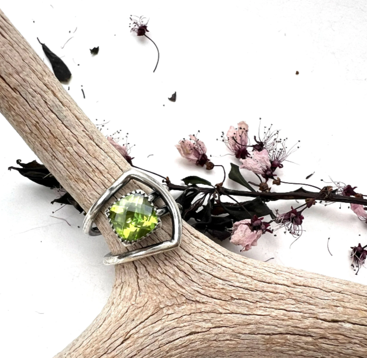 Sterling silver ring featuring a faceted green stone