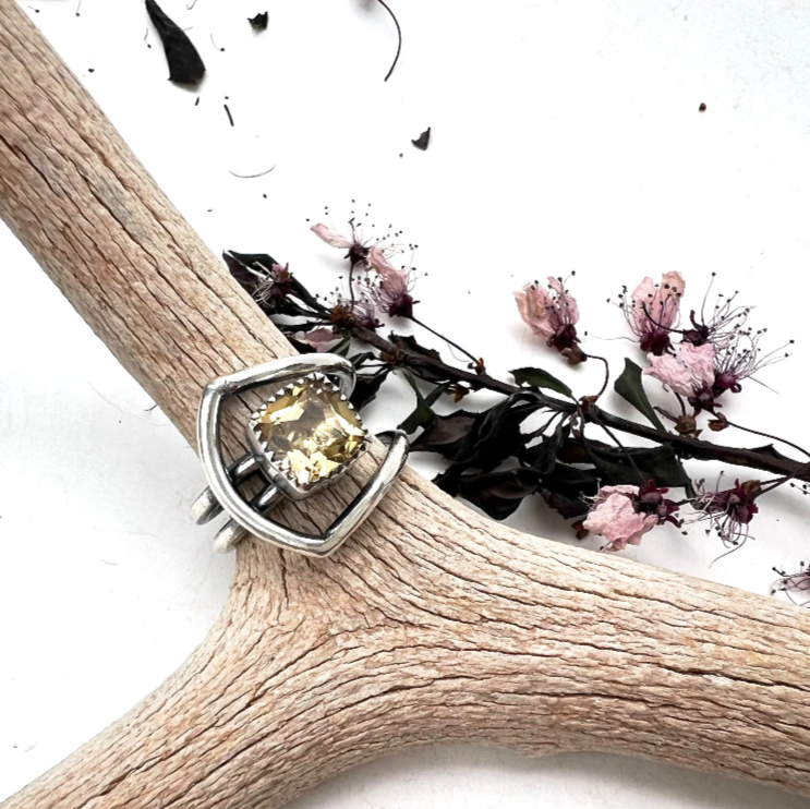 Sterling silver gemstone ring with a faceted golden stone