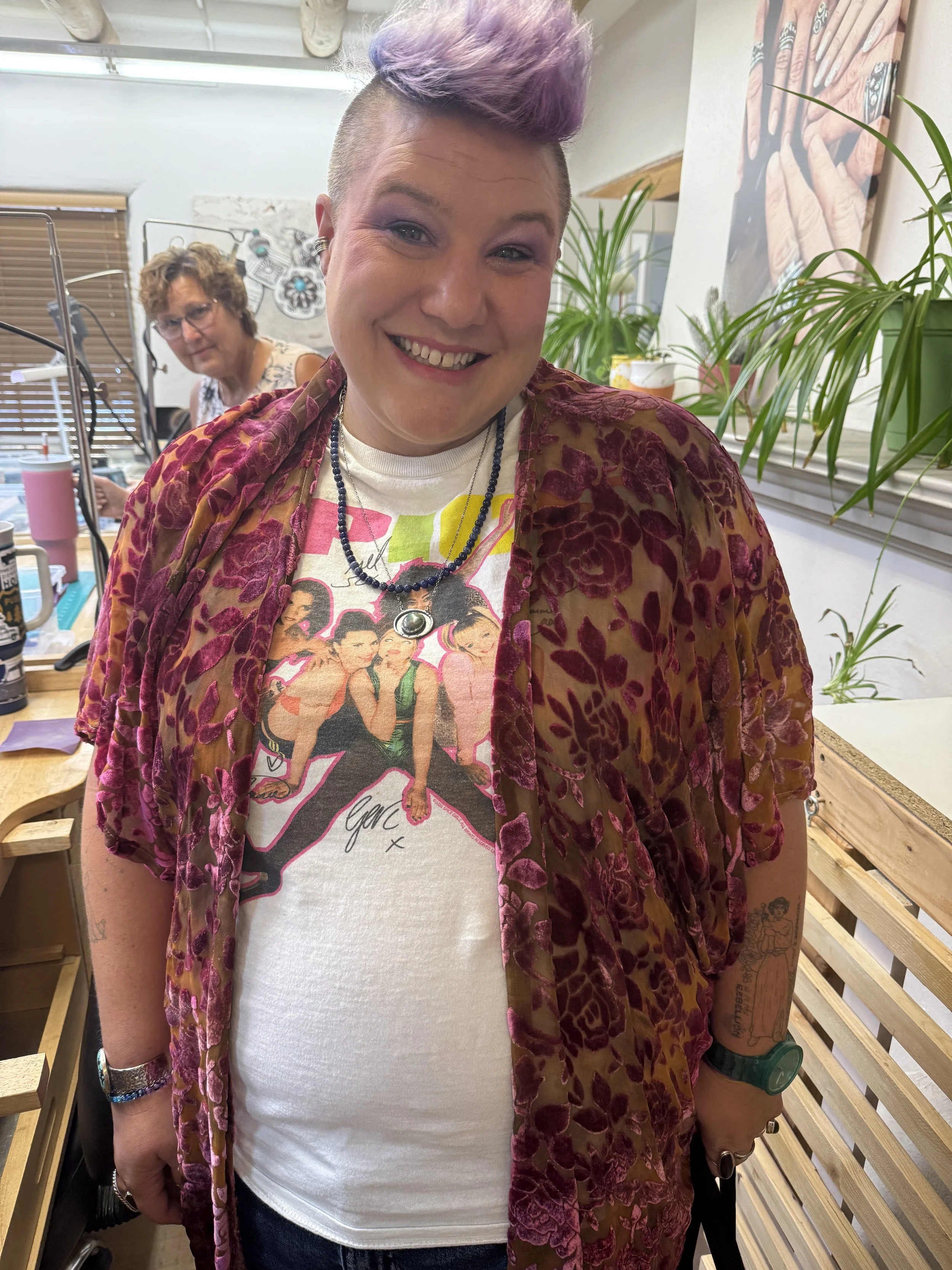 Student smiling while wearing the handmade necklace.