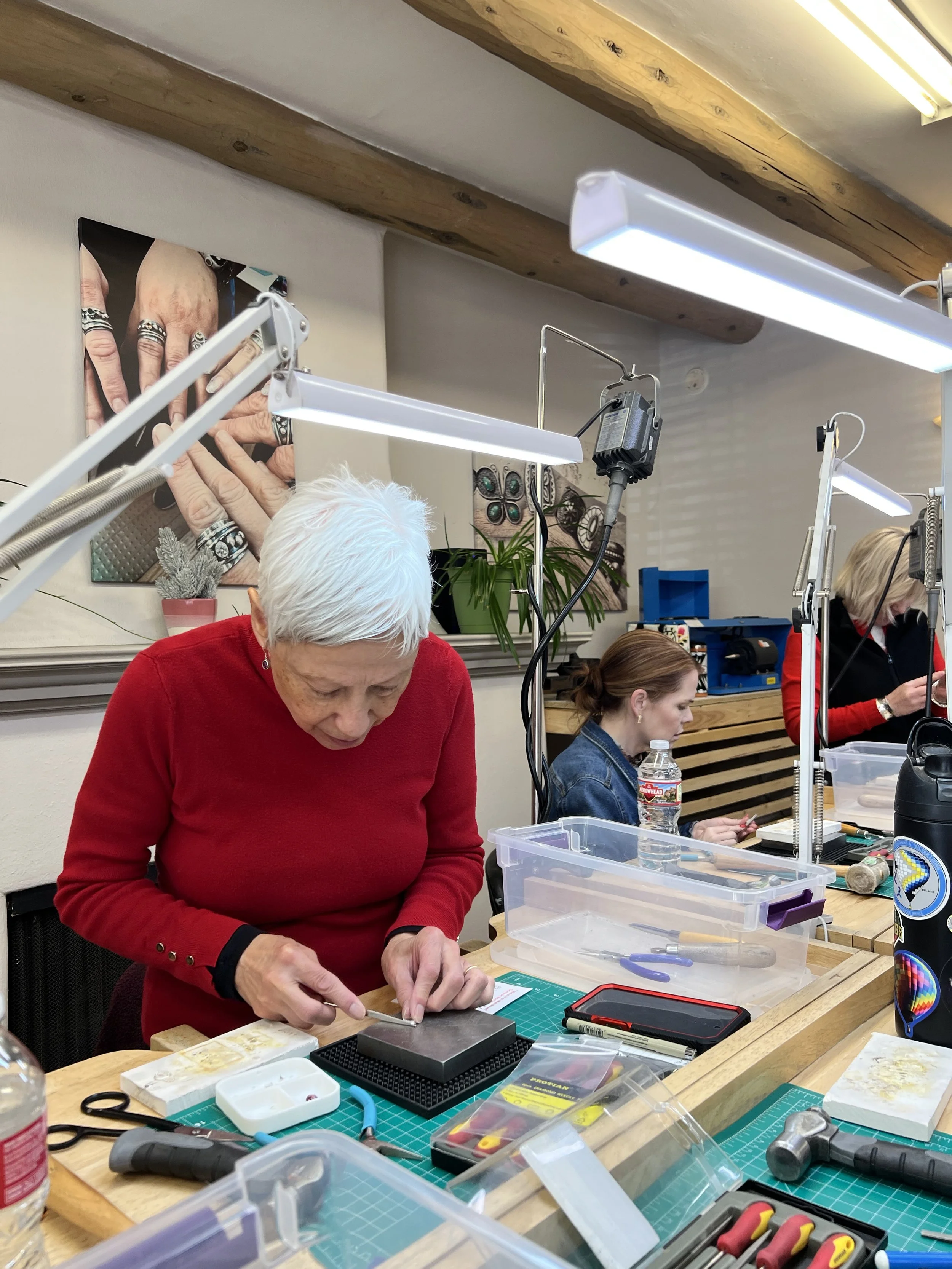 Student practicing jewelry-making techniques at the workbench