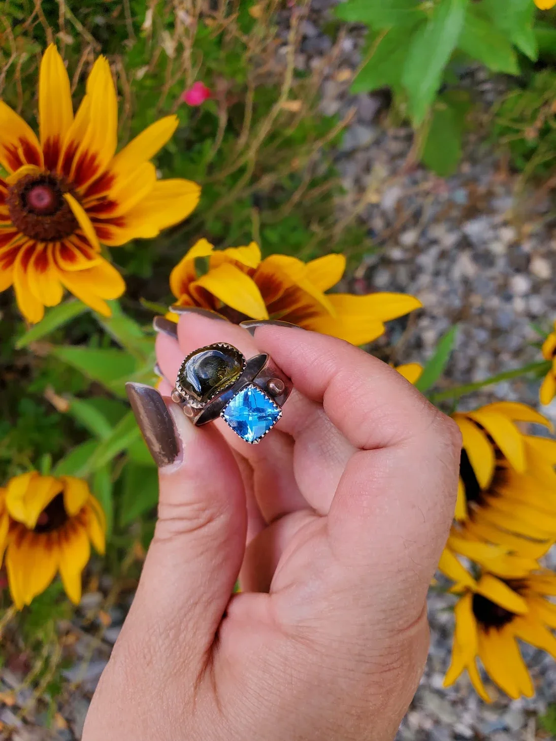 Student showing their finished handmade jewelry piece.