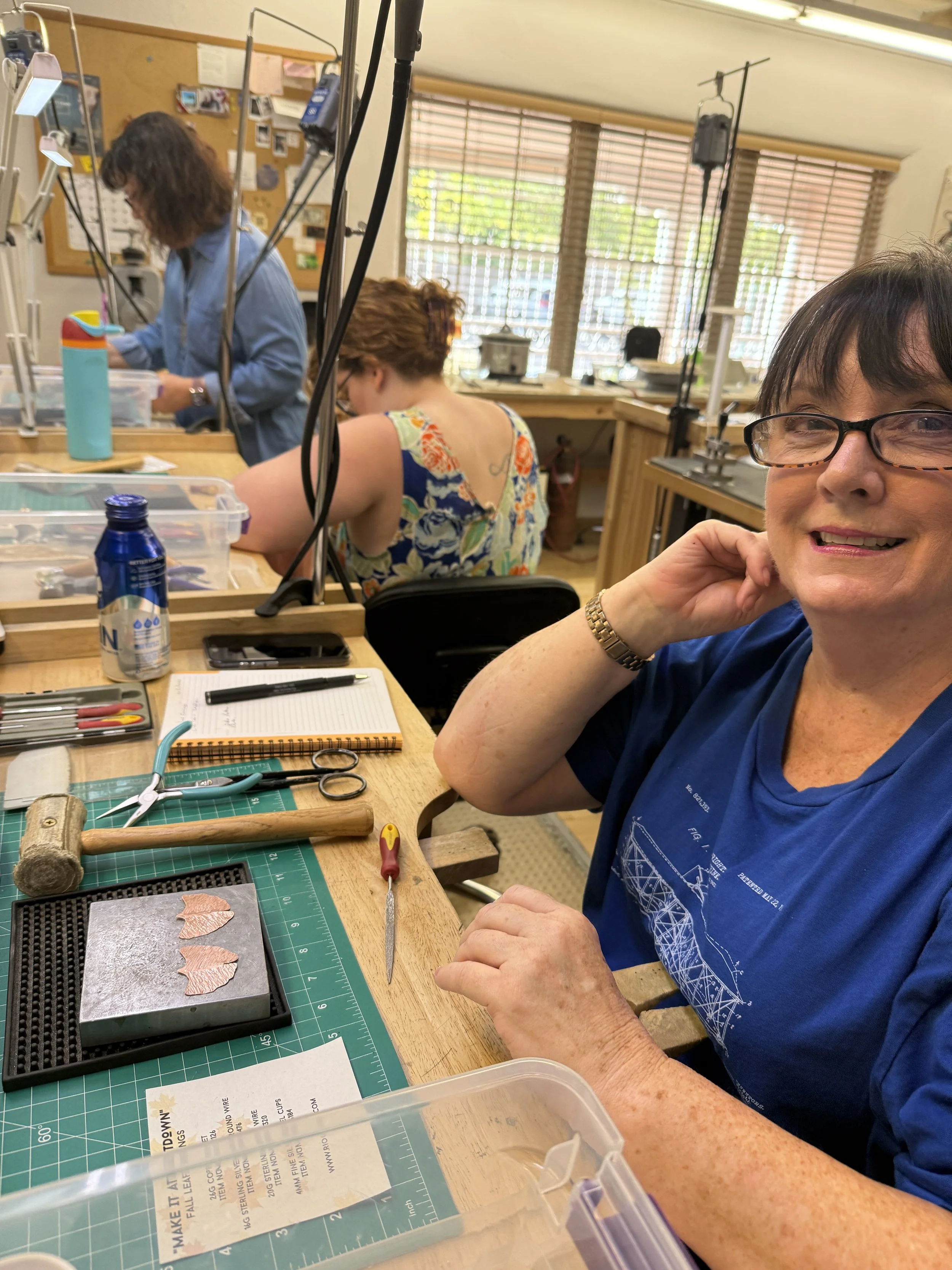 Student working on copper leaf earrings