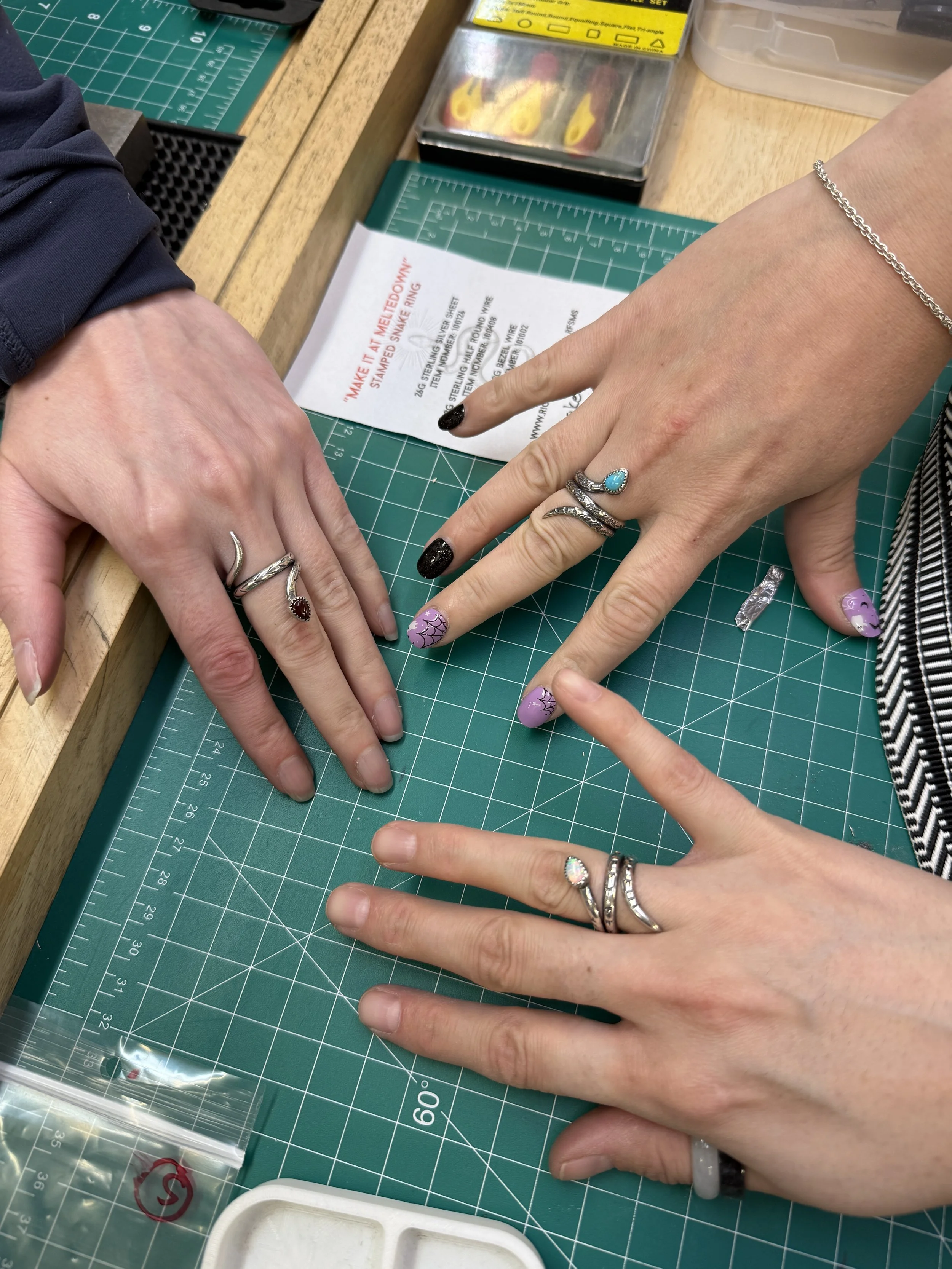 Students proudly wearing their handmade silver snake rings