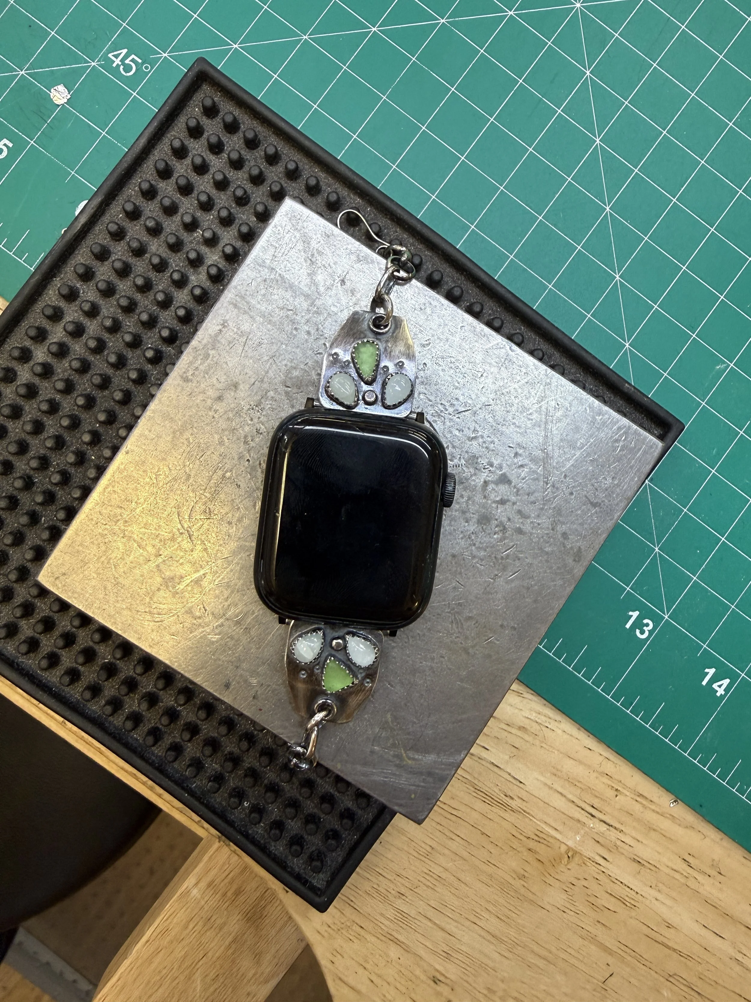 Finished watch band with handmade silver panels and pale cabochon stones