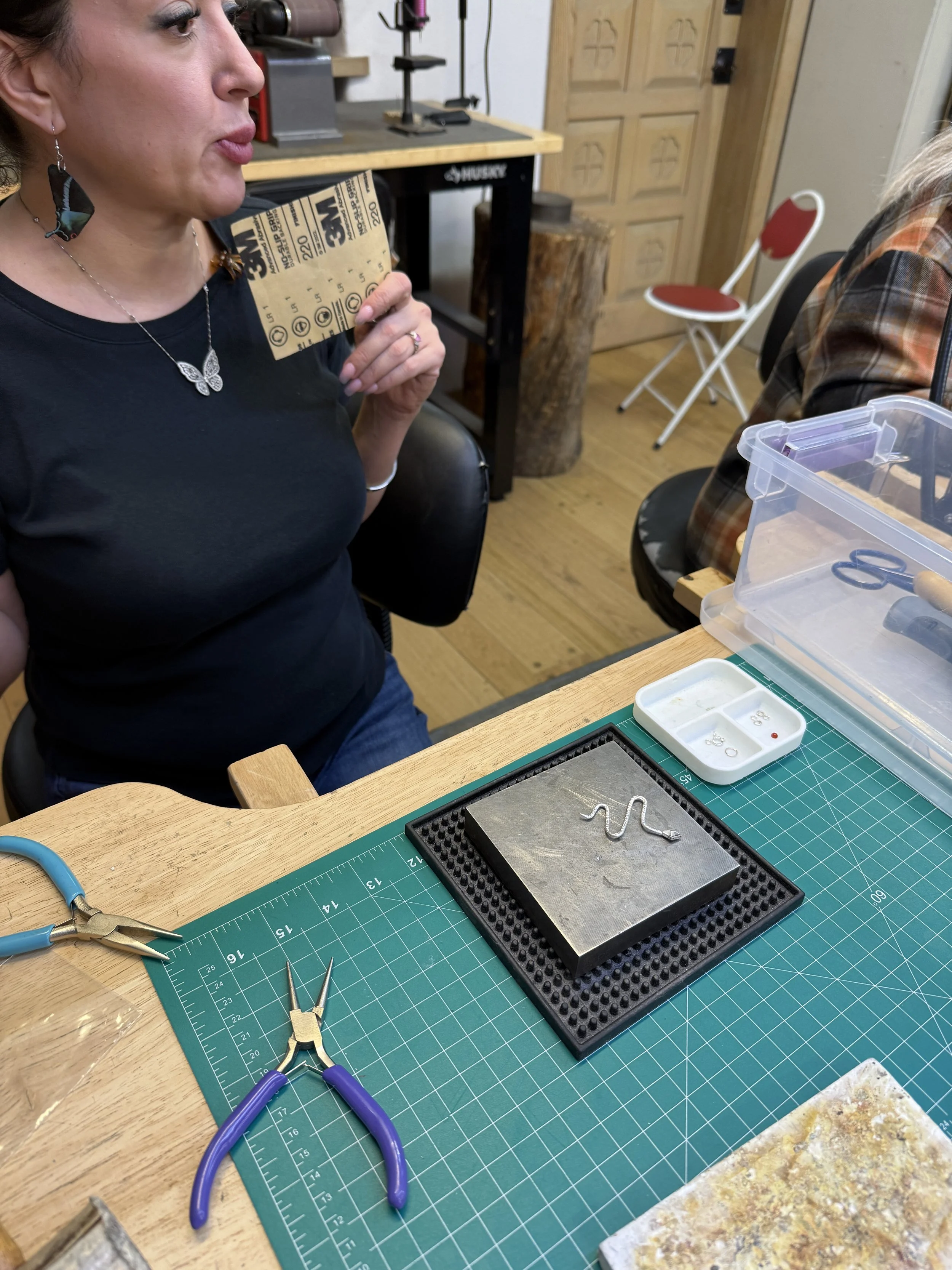 Student preparing to refine a small metal jewelry component