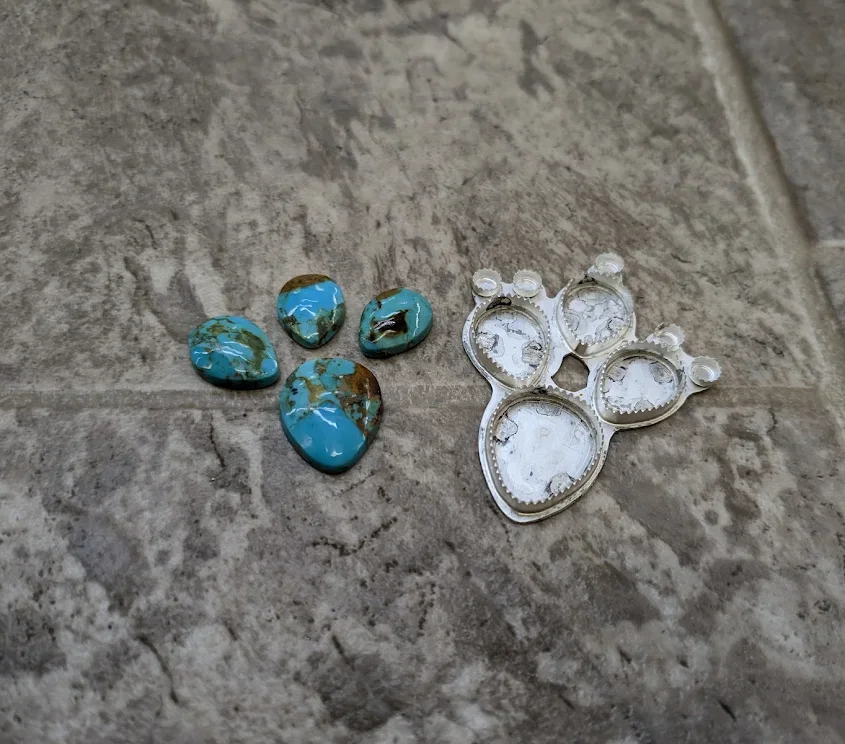 Cabochon stones beside unfinished silver settings
