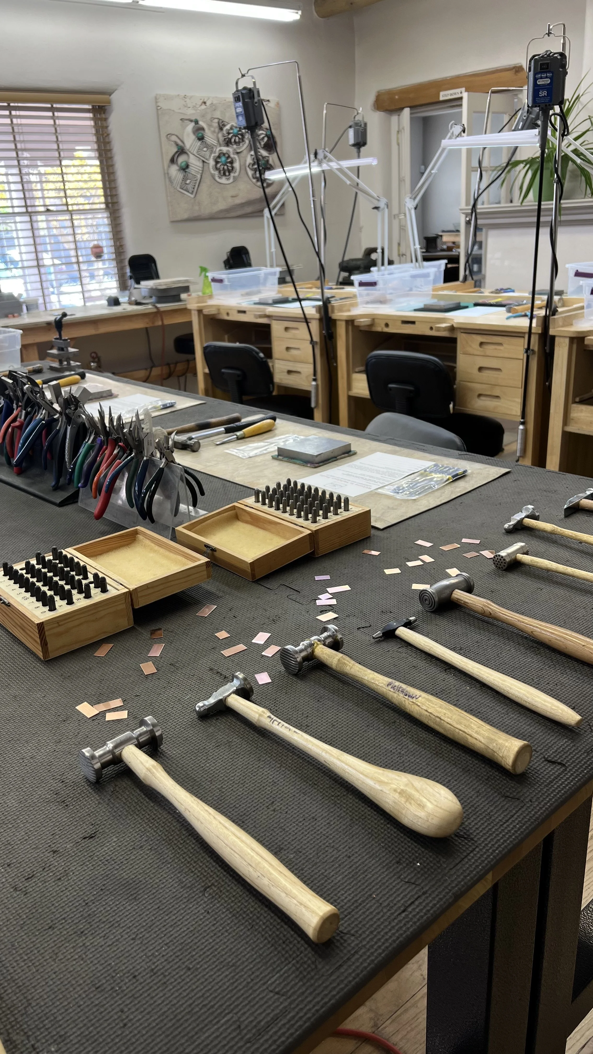 Jewelry-making tools arranged on a workbench