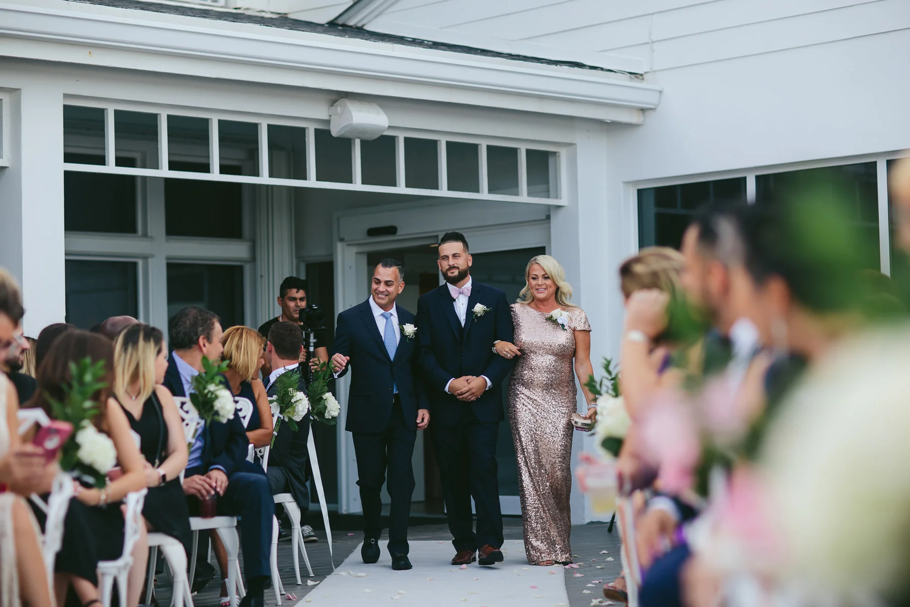 groom-parents-ceremony-walk-wedding-day-tiny-house-photo.jpg