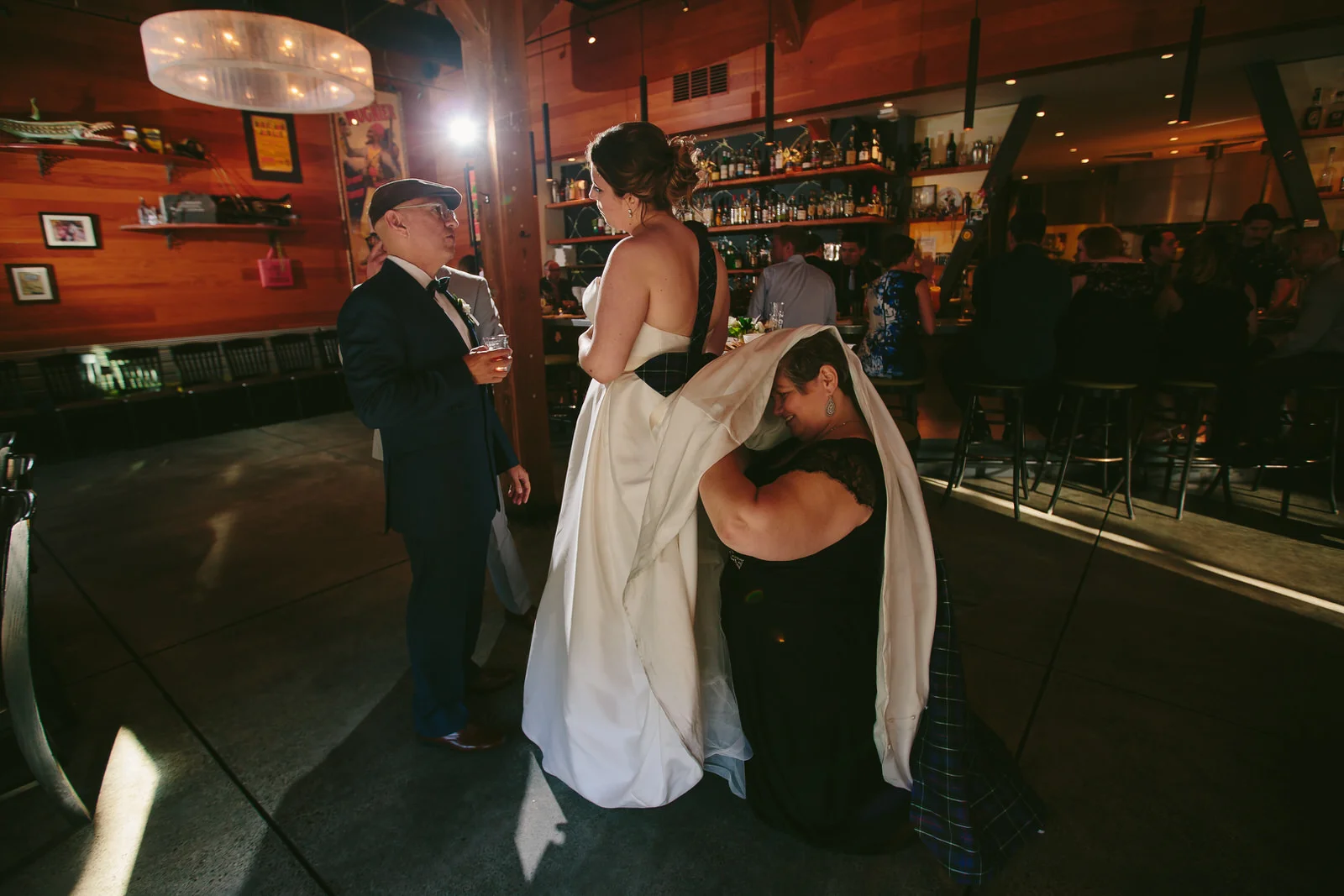moments_wedding_reception_hilarious_bustle_bride_tiny_house_photo.jpg