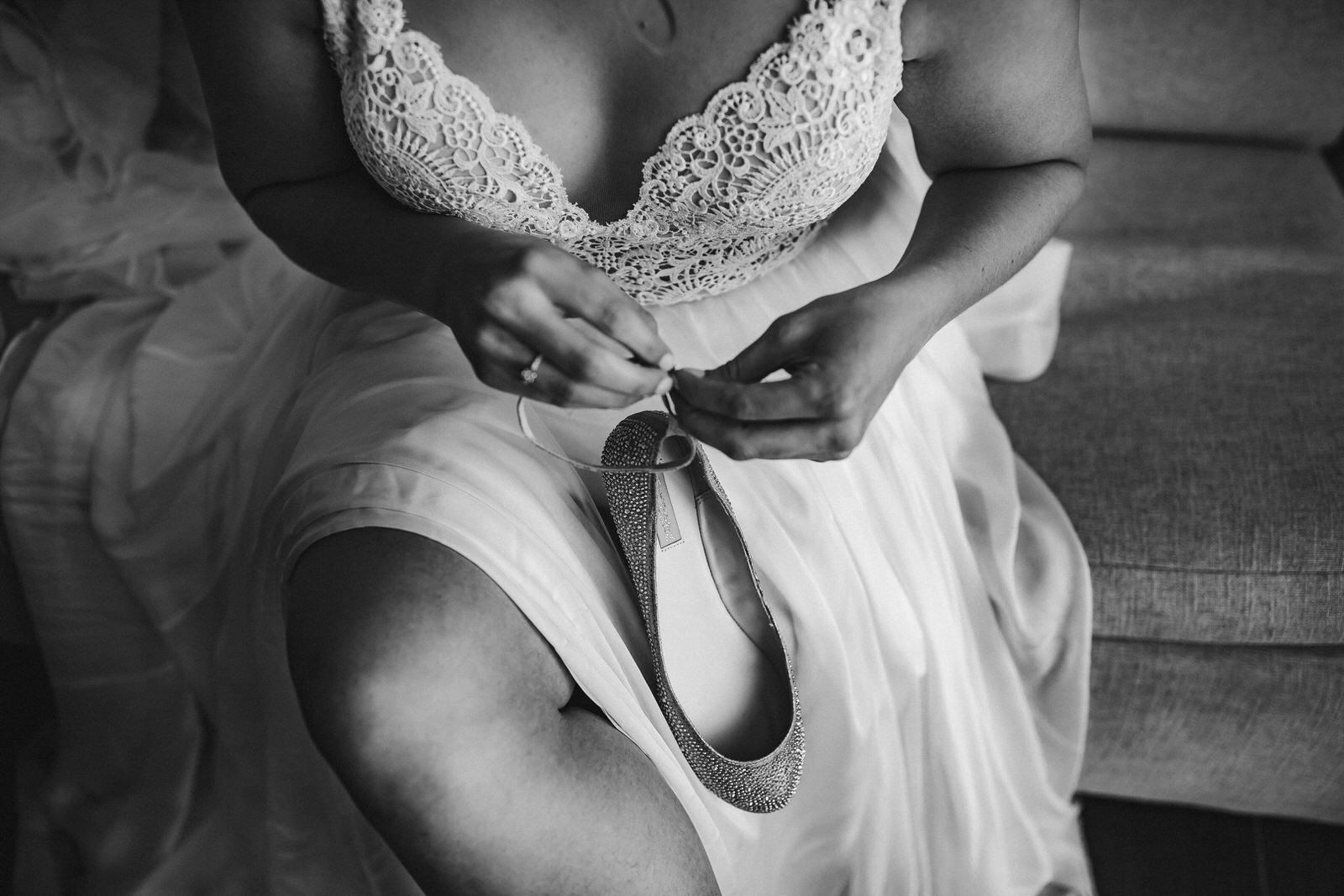 bride_getting_ready_shoes_black_and_white_wedding_photography.jpg