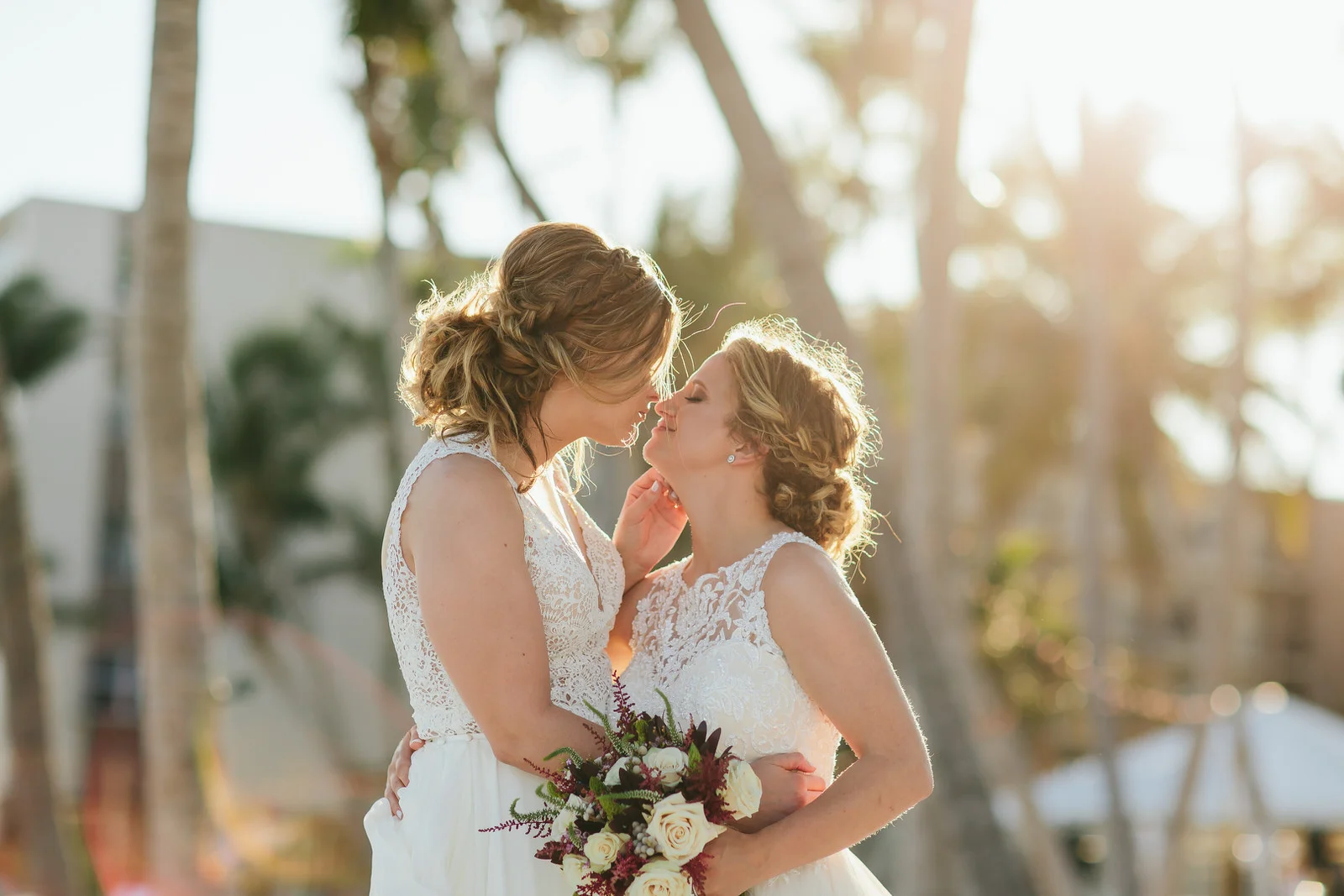 LGBTQ+ couple had a destination wedding at Amara Cay Resort in Islamorada, FL. Couple is kissing during golden hour on the beach.