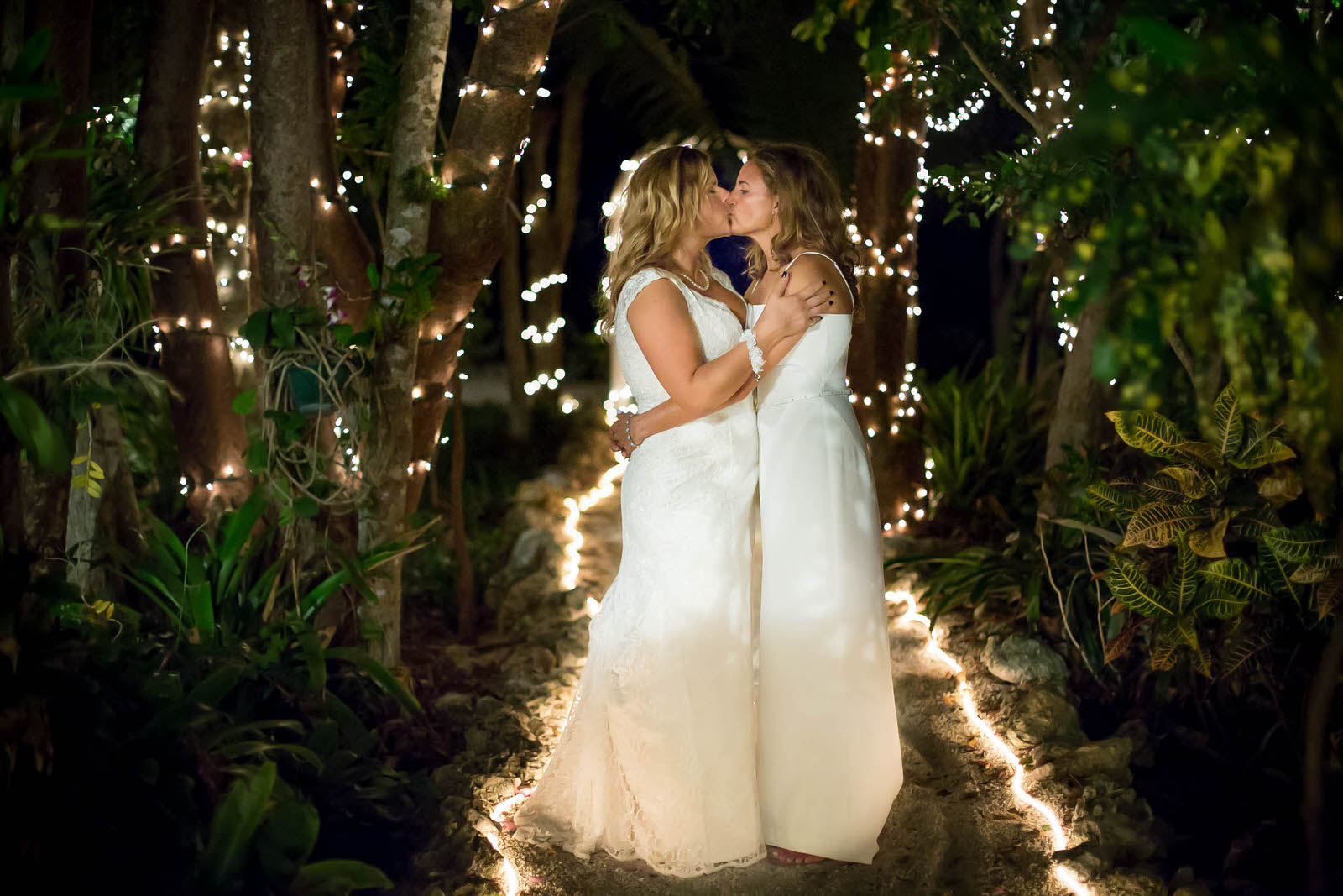 intimate-wedding-lgbtq-florida-keys-tiny-house-photo-brides-kissing-twinkle-lights.jpg