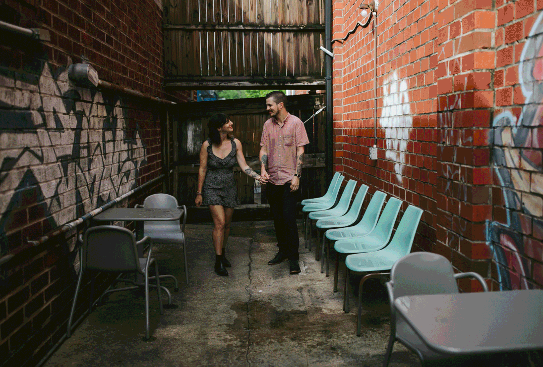 rad vegan couple holding hands and walking to grab coffee in murray hill neighborhood of jacksonville, florida