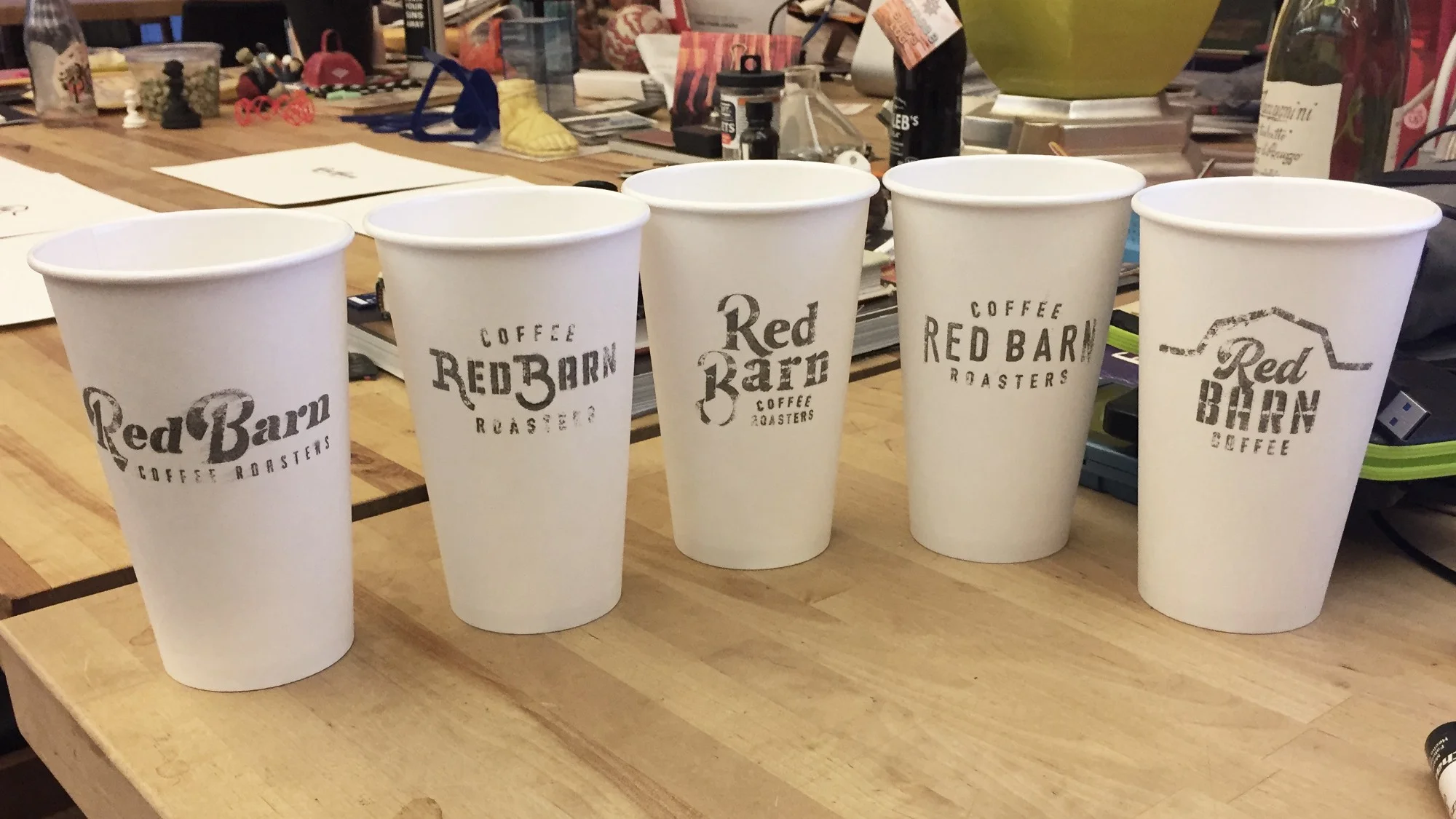 Adam presented his first round of logos on coffee cups.