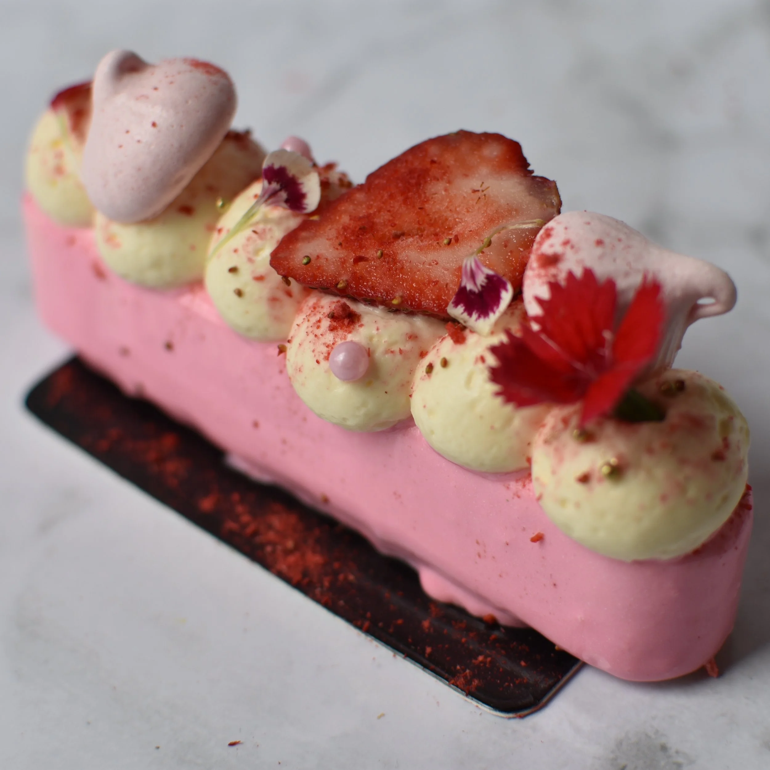 STRAWBERRIES N CREAM Strawberry sponge base, baked vanilla cheesecake, cream cheese mousse, strawberry compote, glaze. $7.90 each Minimum Order Quantity : 10
