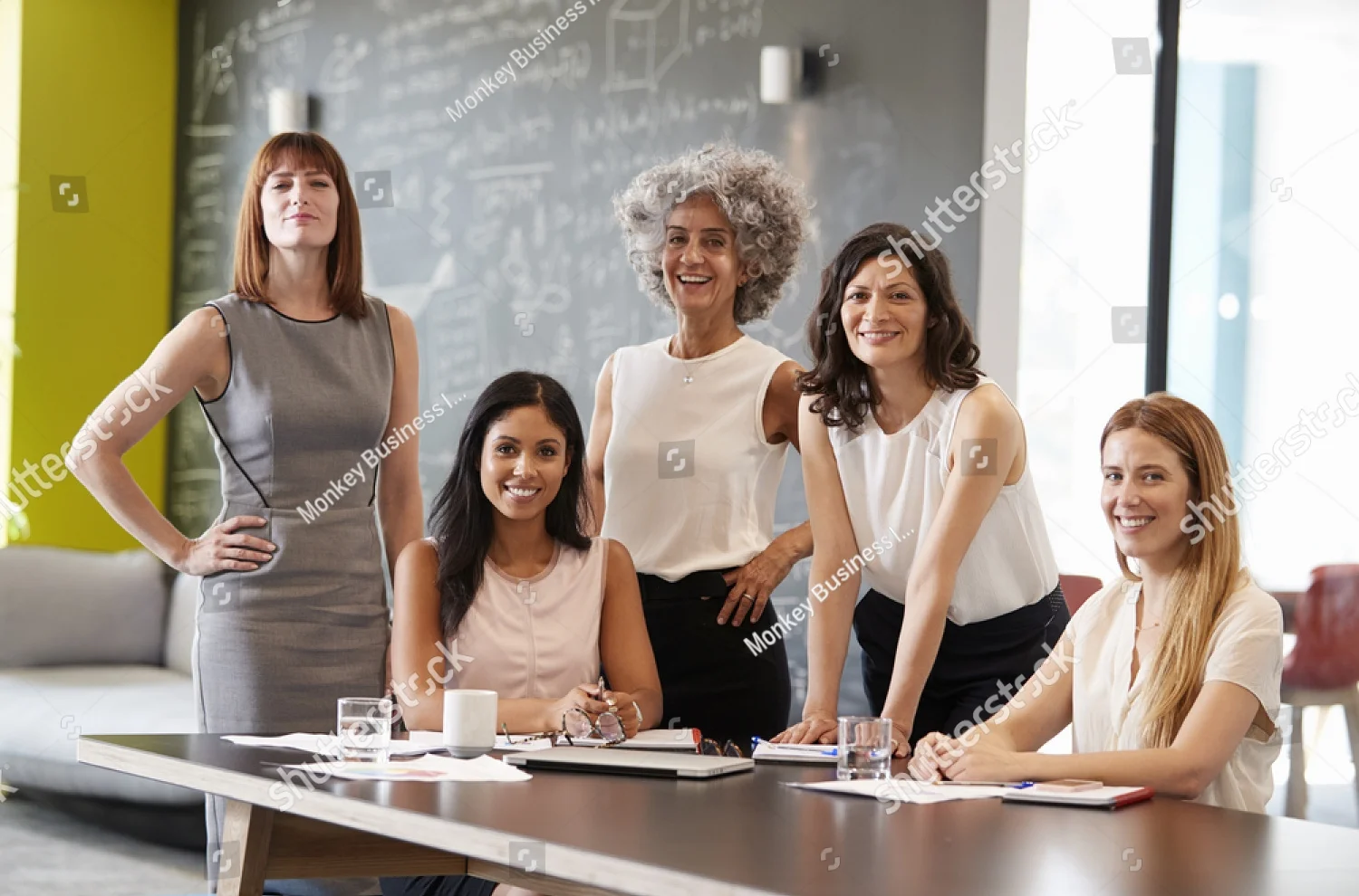 stock-photo-five-female-colleagues-at-a-work-meeting-smiling-to-camera-749253997.jpg