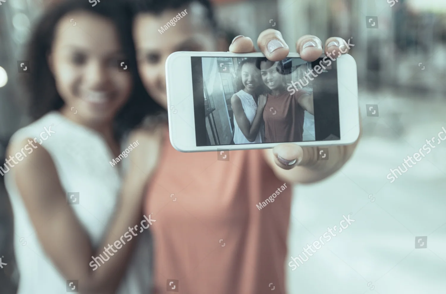stock-photo-closeup-portrait-of-two-smiling-black-beautiful-girls-taking-selfie-photo-in-with-focus-on-1132451237.jpg