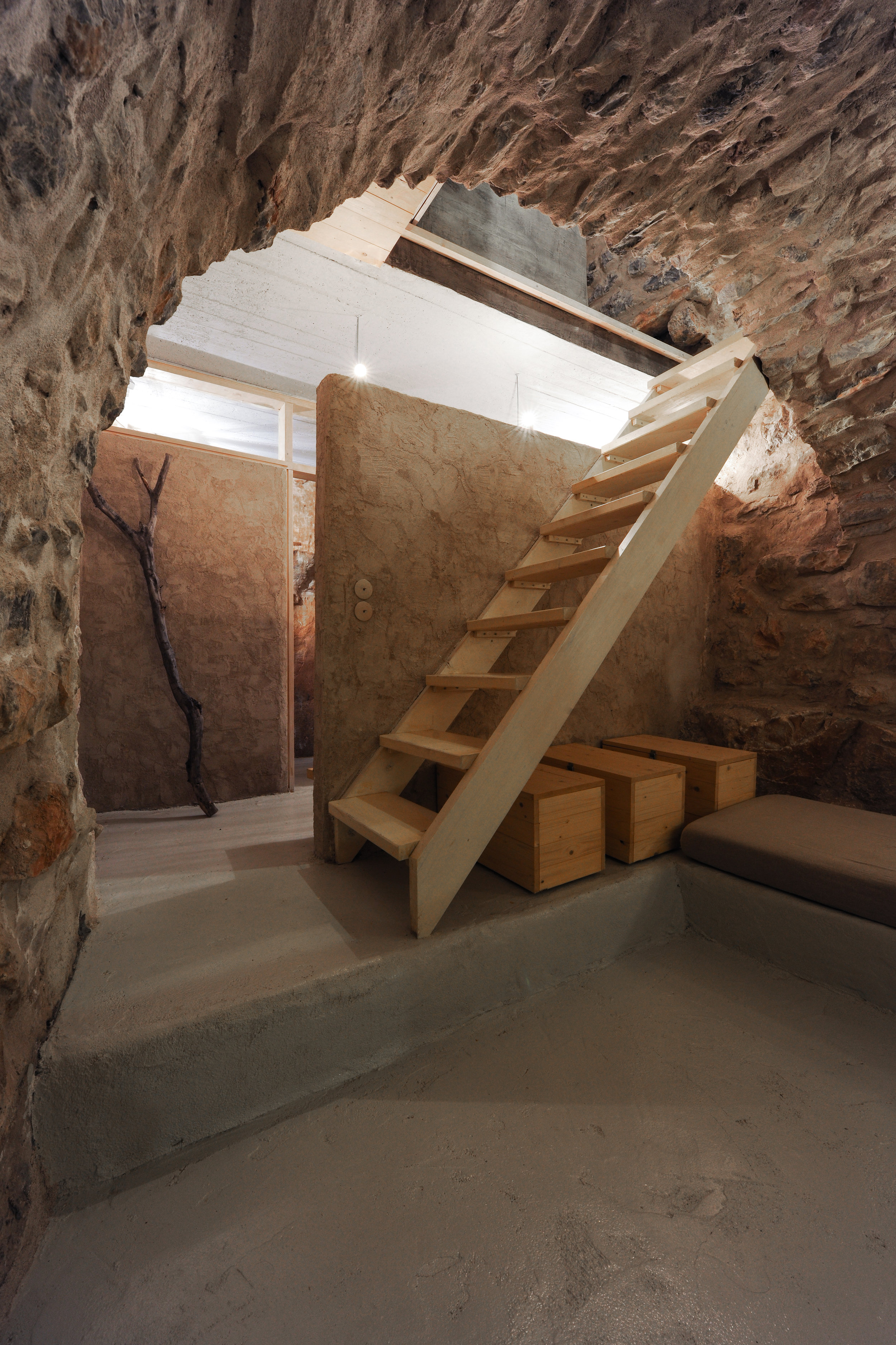 A half-height wall, isolates the bedroom from an open closet, beyond which lies the bathroom.