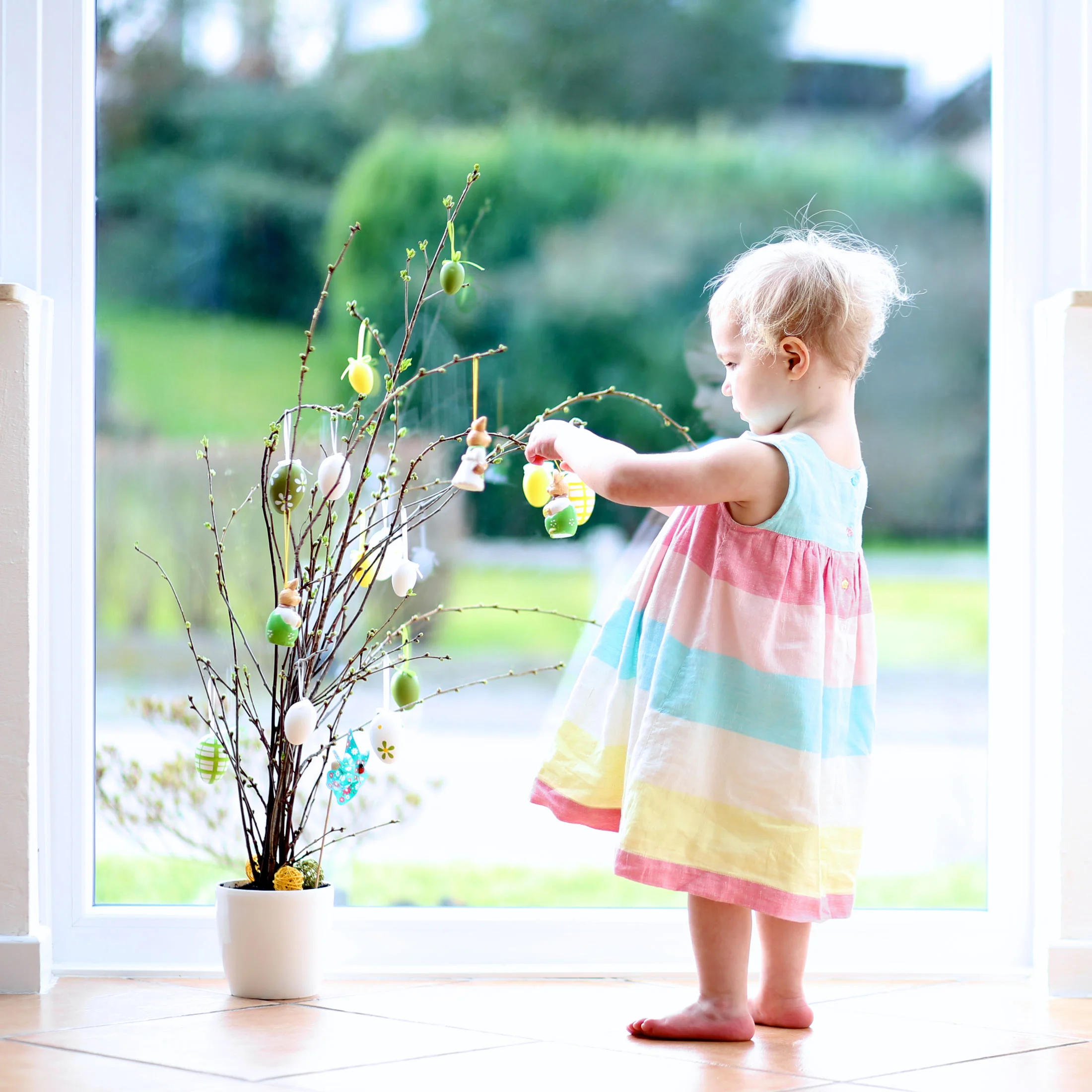 Dressing the Easter tree/twigs (photo by CroMary via Shutterstock)