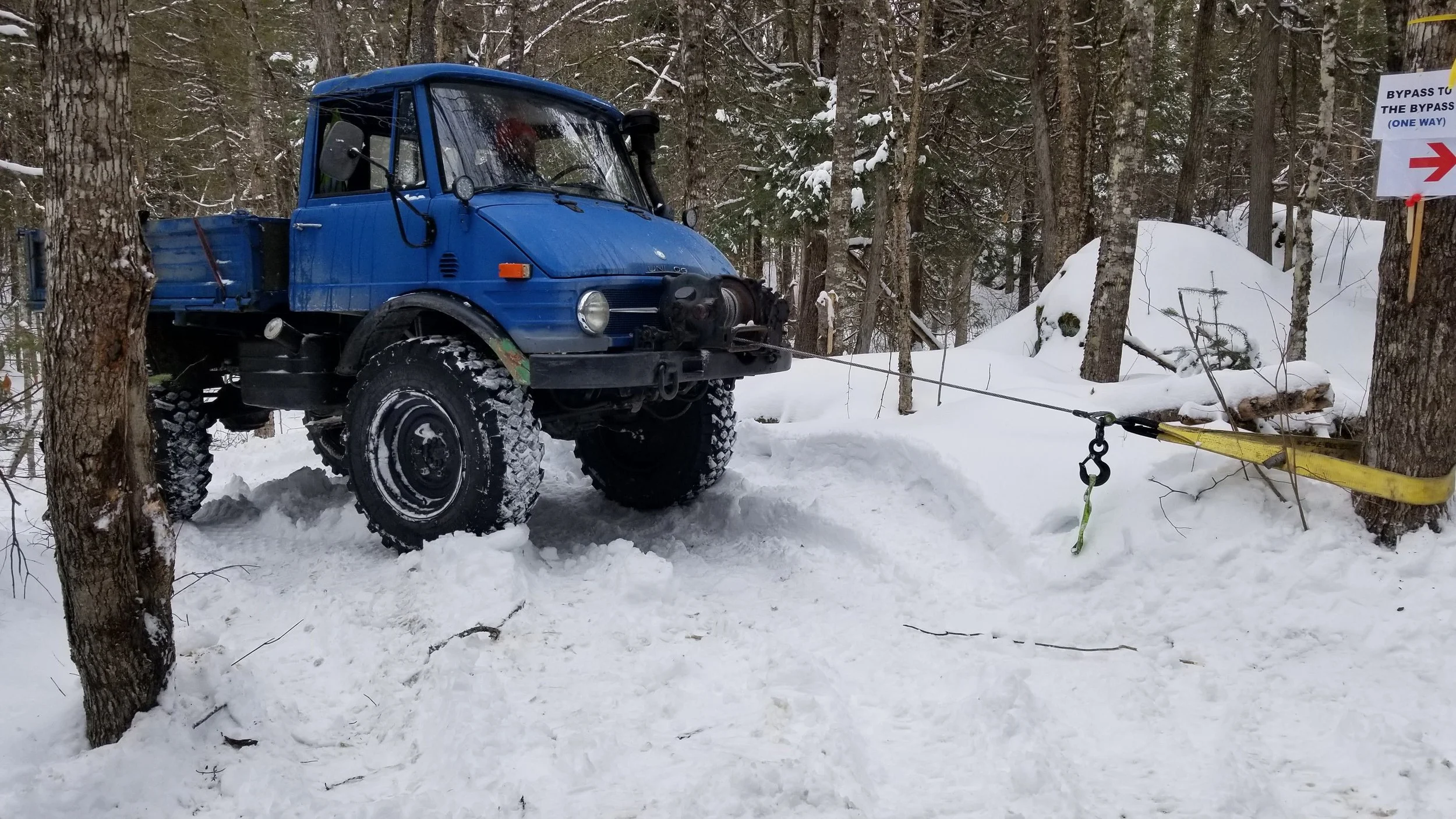 Unimog 406 winching through snow in the Maine woods