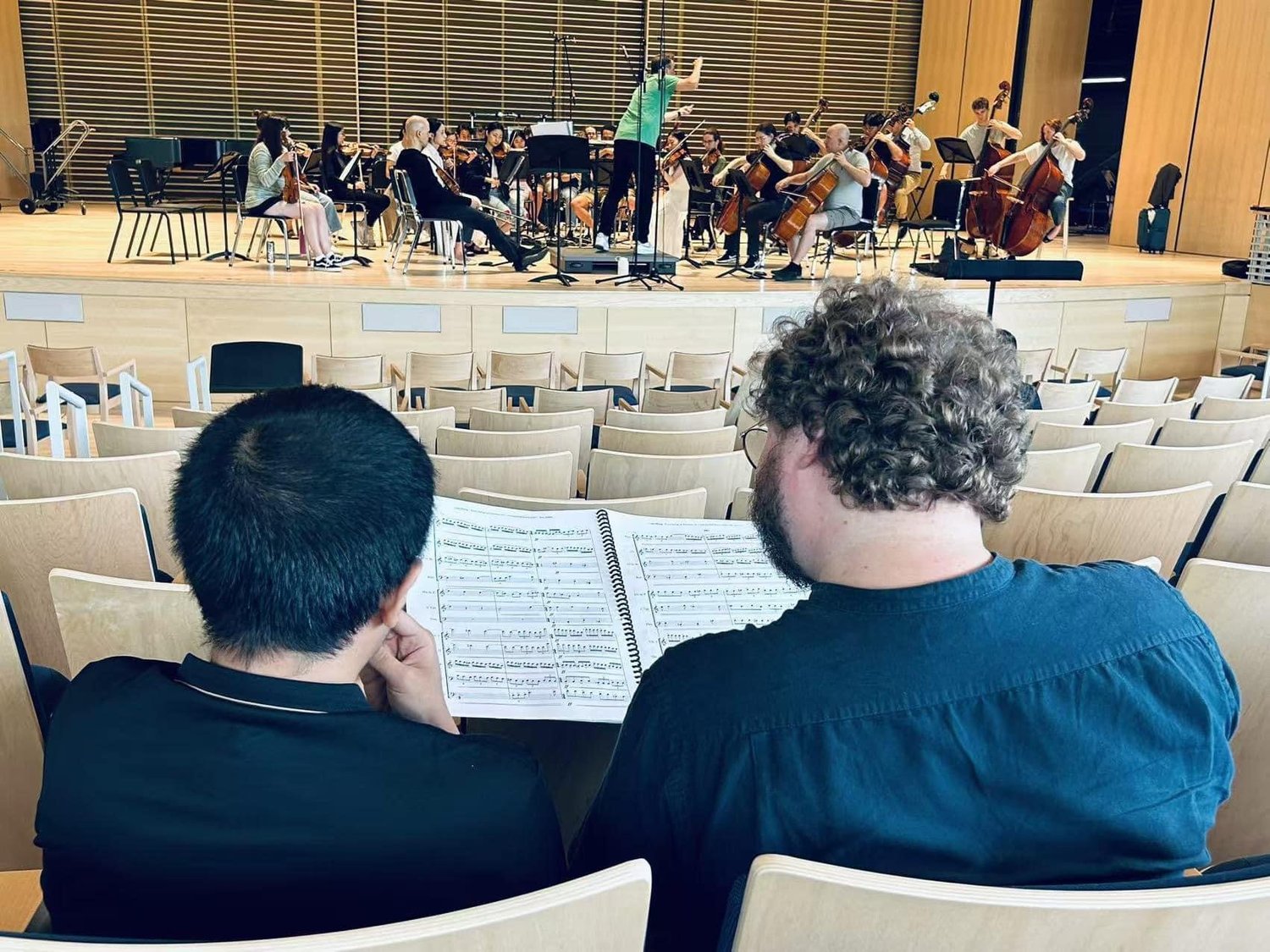 Stephen Cabell reviewing an orchestral score with a composer