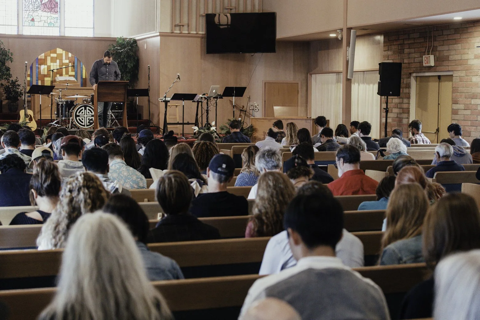 Announcement for an upcoming prayer night at Gospel Community Church in Santa Cruz, CA. Image is of a pastor praying with his congregation.
