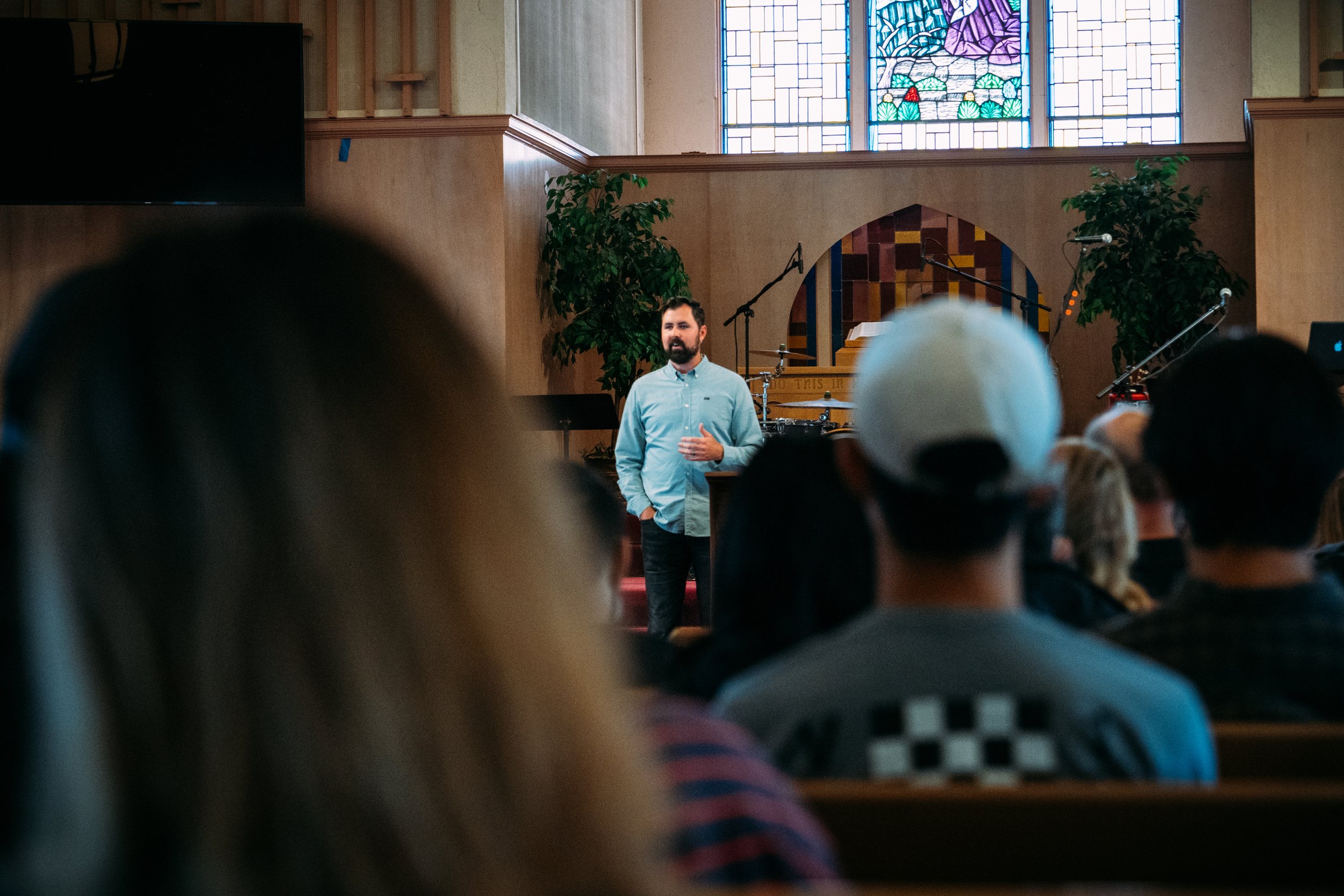 Announcement for an upcoming guest speaker preaching at Gospel Community Church. Image is of a pastor preaching.