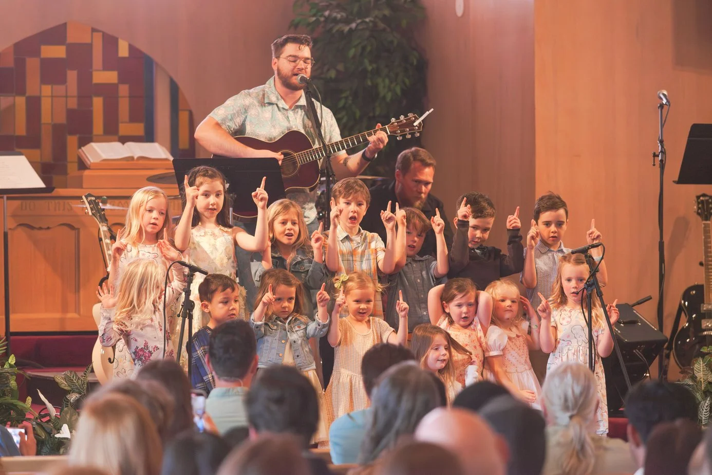 Children sing a song on stage for Gospel Community Church's Easter service in Santa Cruz, CA.