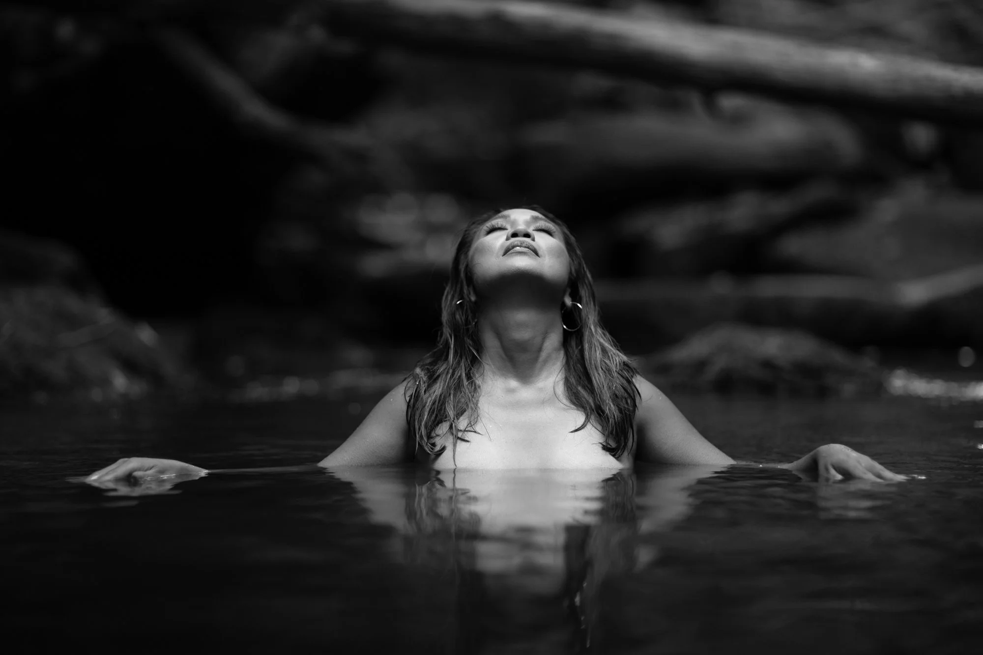 Black and white outdoor boudoir portrait of a woman in chest-deep water in the Blue Ridge Mountains near Charlottesville.