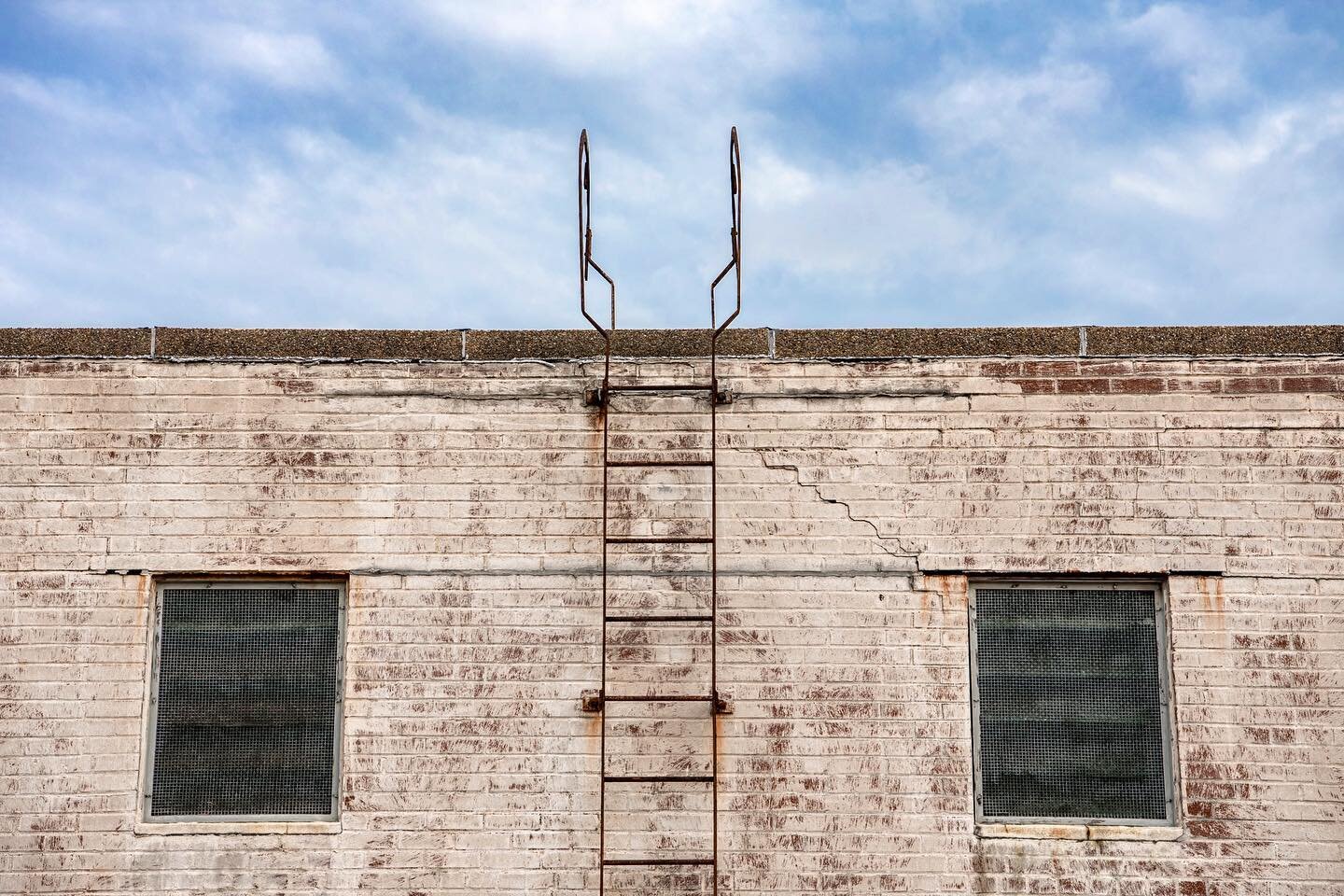 This ladder goes up to the roof of the mechanical room, but all I see is a pool ladder. From the rooftop of 222 Mitchell Street for @southdwntn, previously a C&amp;S Bank office building.