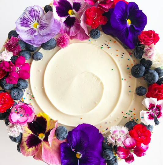 A signature style flower-clad cake by Goldenrod Pastries on Instagram.