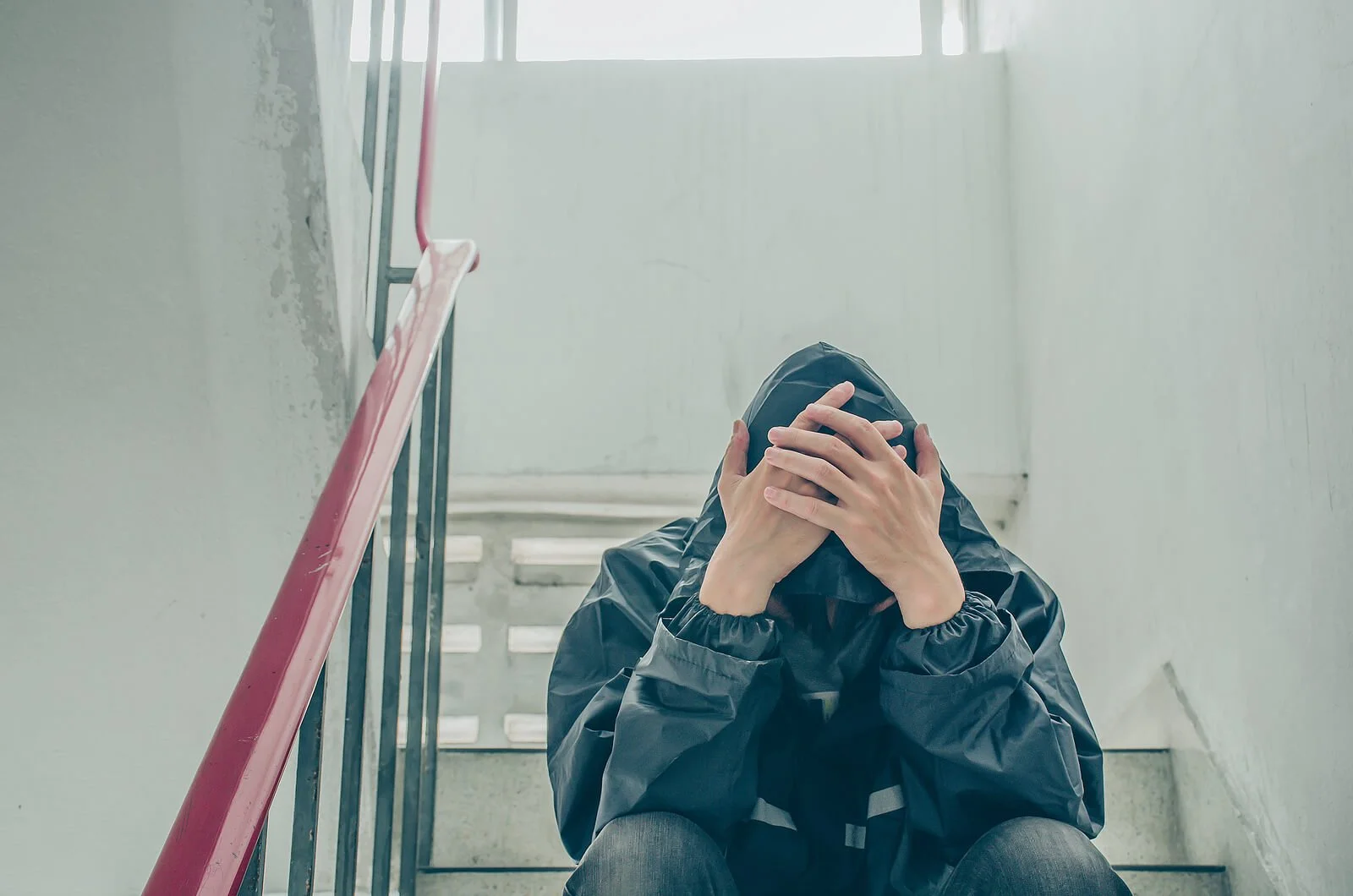 A man sits on a stairwell with his hands on his head. Has your trauma-related anxiety in Los Angeles, CA stopped you from being happy? Trauma therapy in Los Angeles, CA might be able to help. Reach out to a trauma therapist in California today!