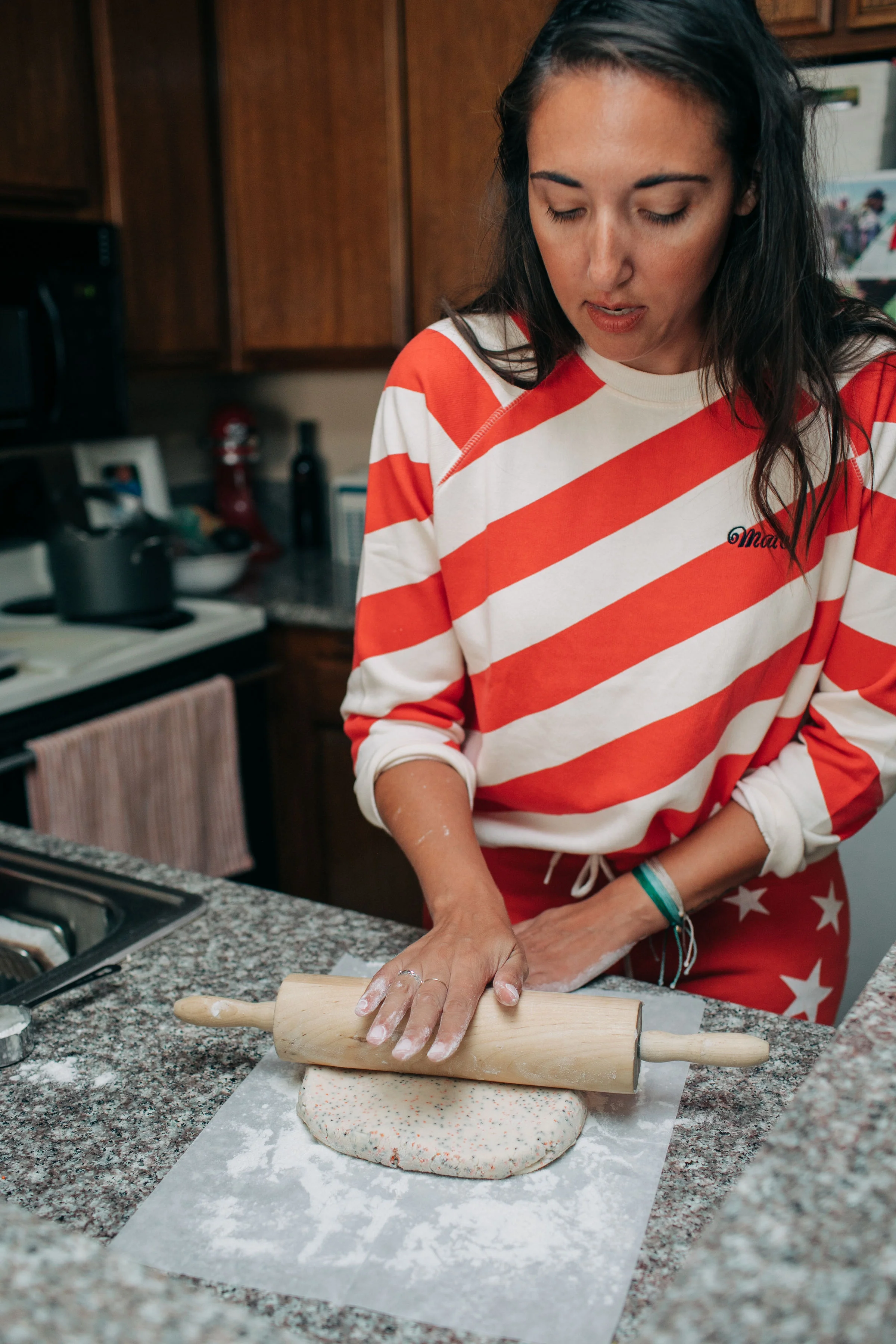 Roll your dough out until it is half an inch thick. I like rolling it out these cookies on floured parchment paper because it keeps things easy after you cut them.