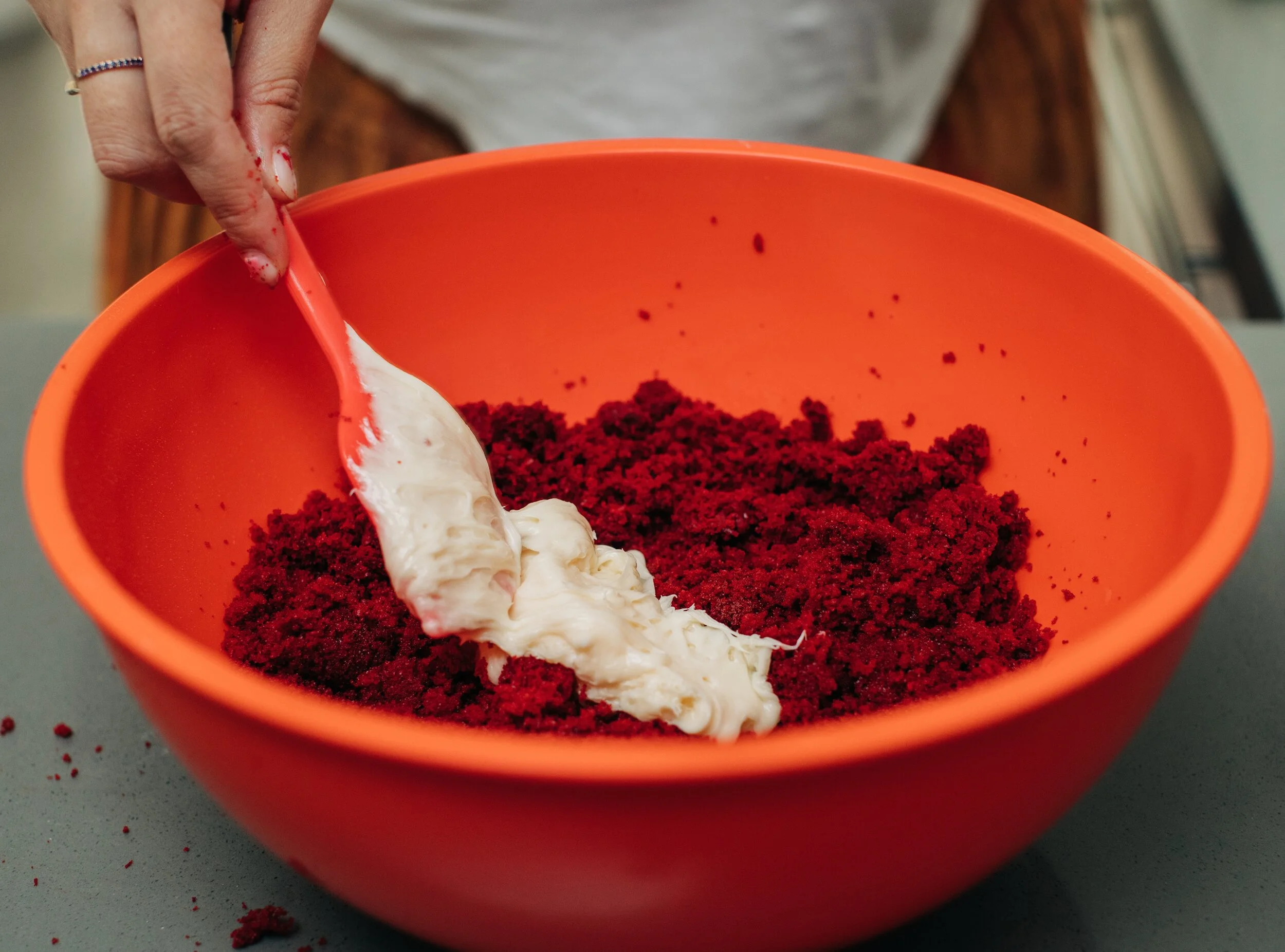 Add your frosting and use your hands to mix until a dough forms.