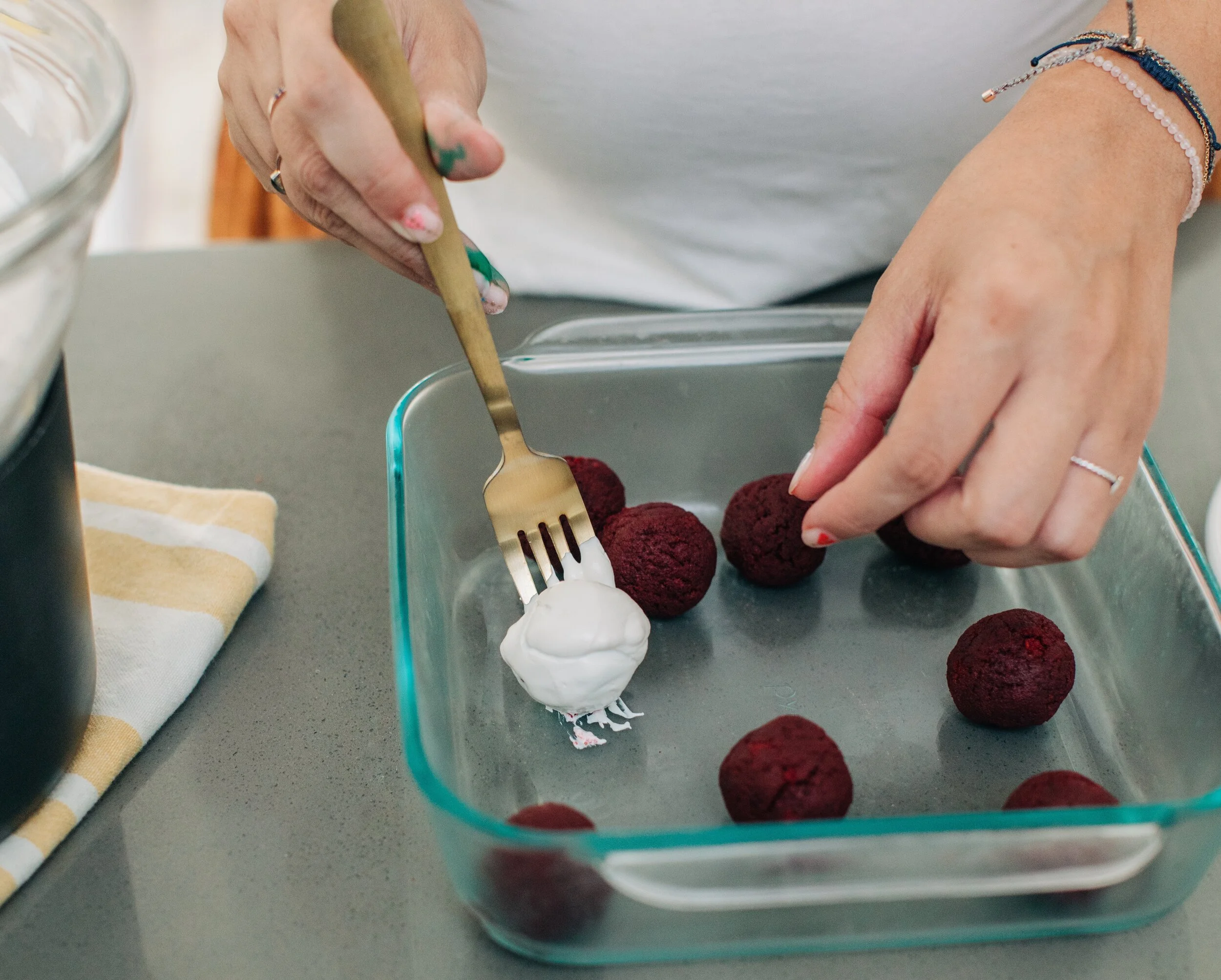 Use a fork to dip and coat your cake bites.