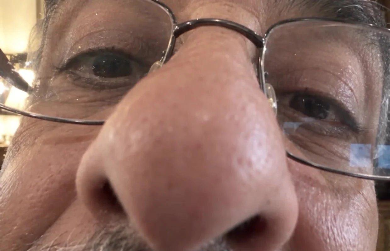 Love Knows No Frames, a father leans close to the video-call camera