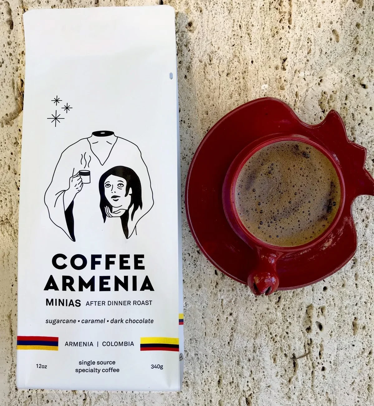 Bag of Coffee Armenia Minias After Dinner Roast next to a cup of Armenian coffee on a pomegranate saucer