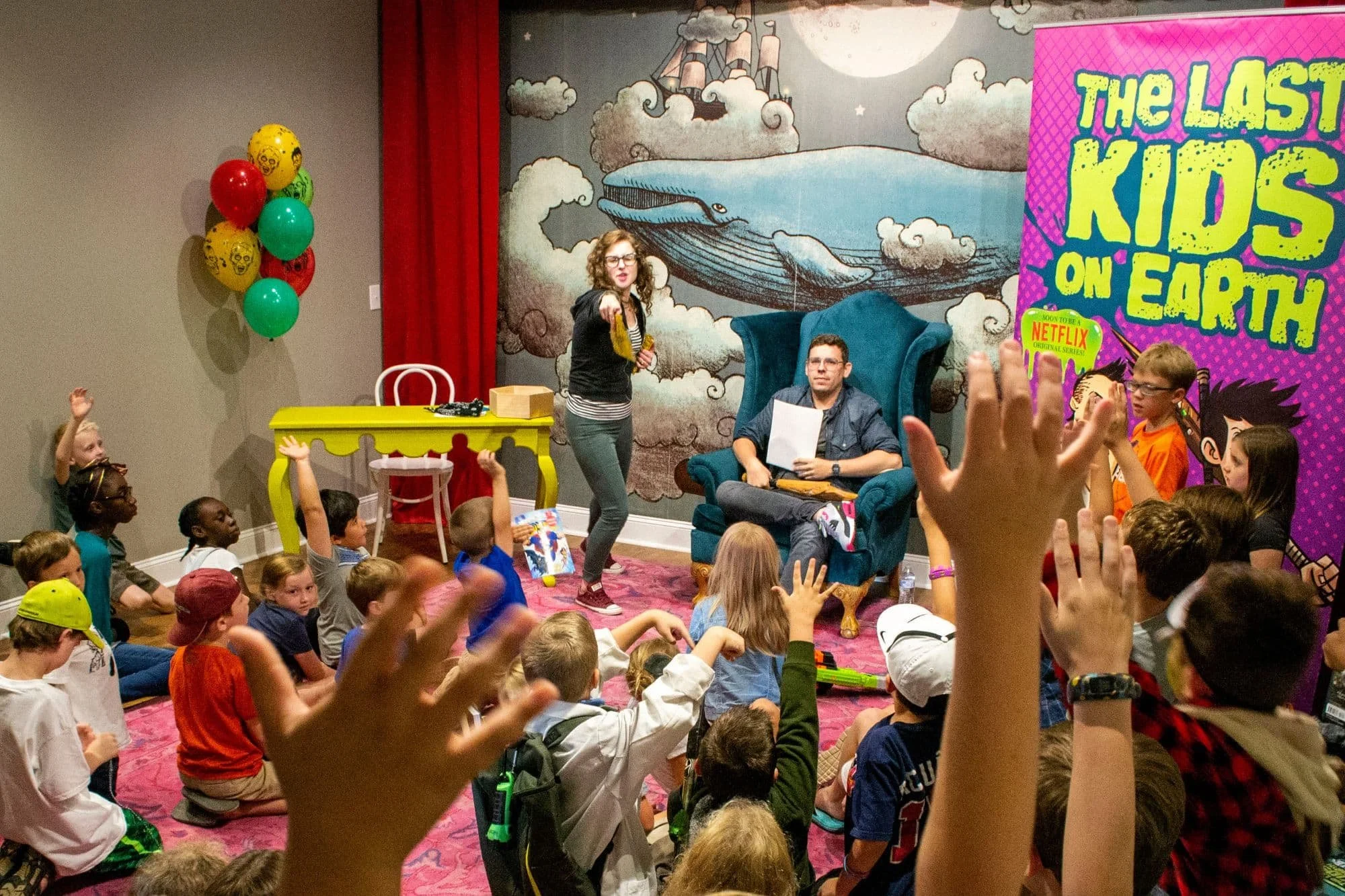 Children's author leading an interactive author event with young readers at The Story Shop bookstore in Monroe, Georgia.