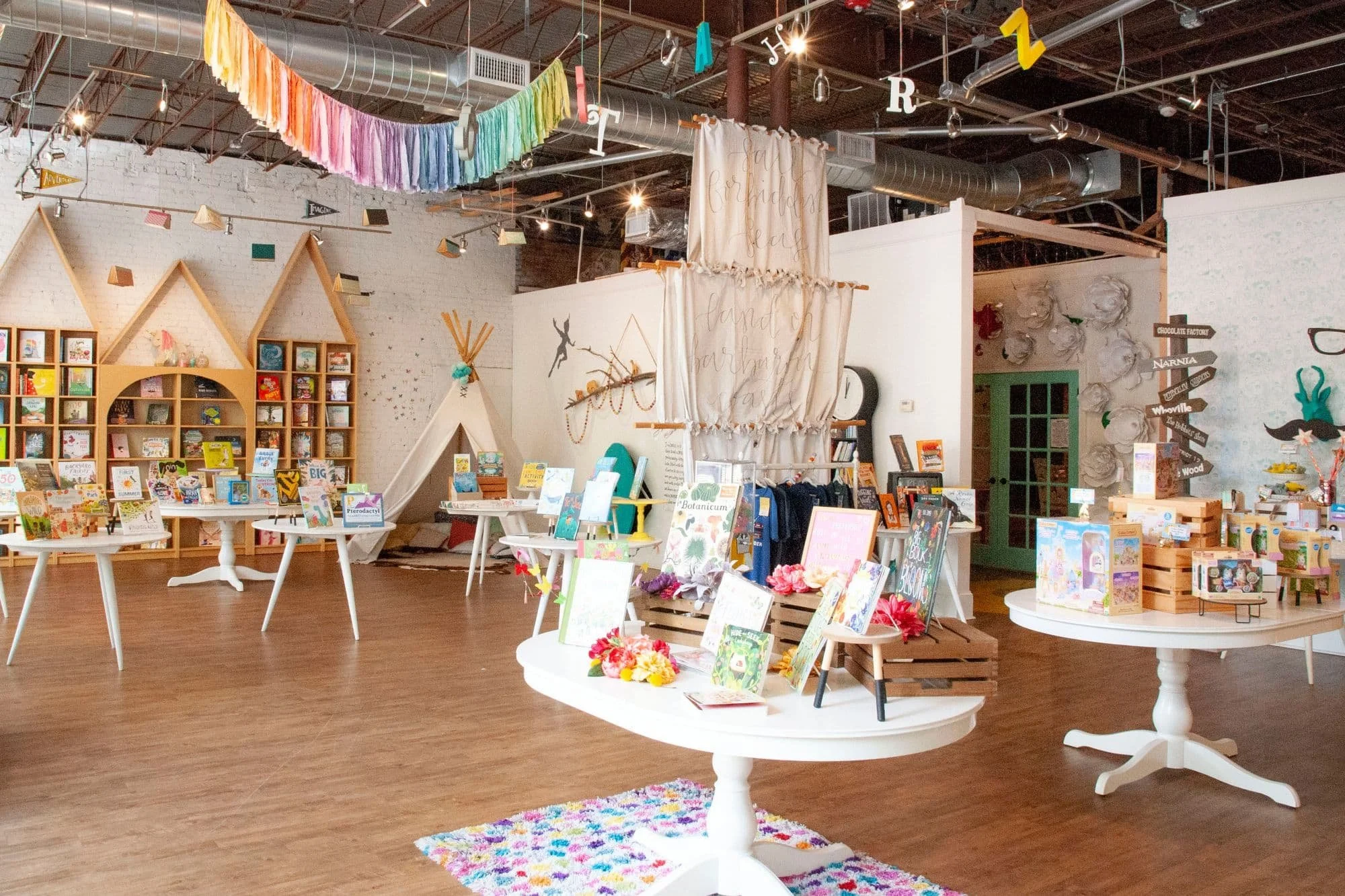 Wide view of The Story Shop, a whimsical children's bookstore in downtown Monroe, Georgia, featuring colorful book displays, imaginative décor, and inviting spaces to explore.