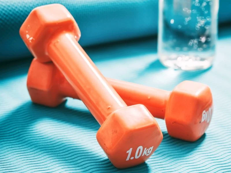 Two orange, one pound weights resting upon one another