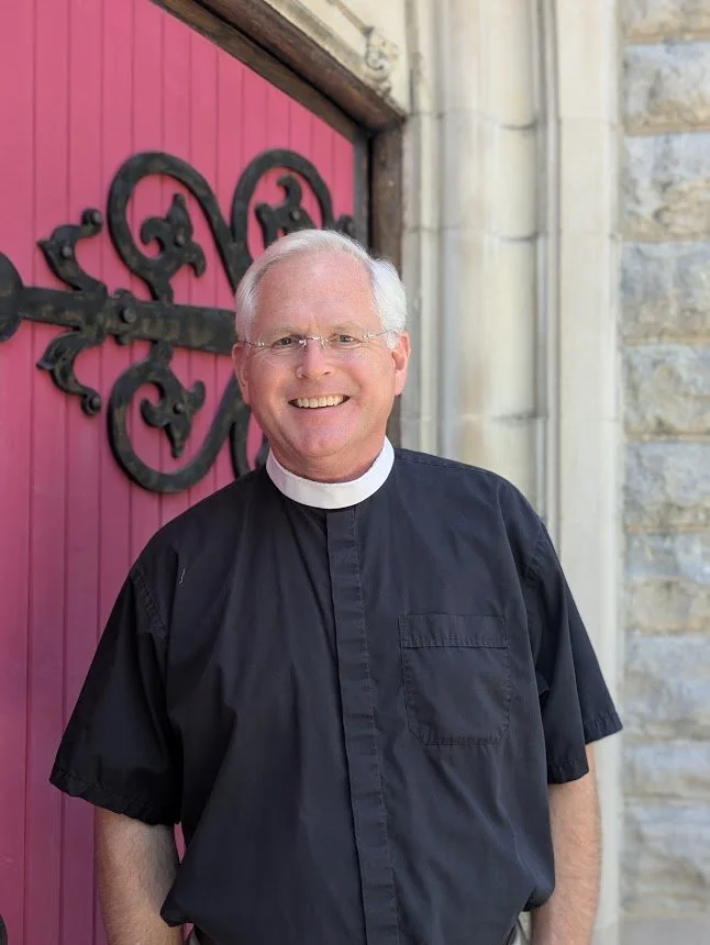 The Rev. David A. Pfaff, Rector of Christ Church Glendale Standing in front of a red door